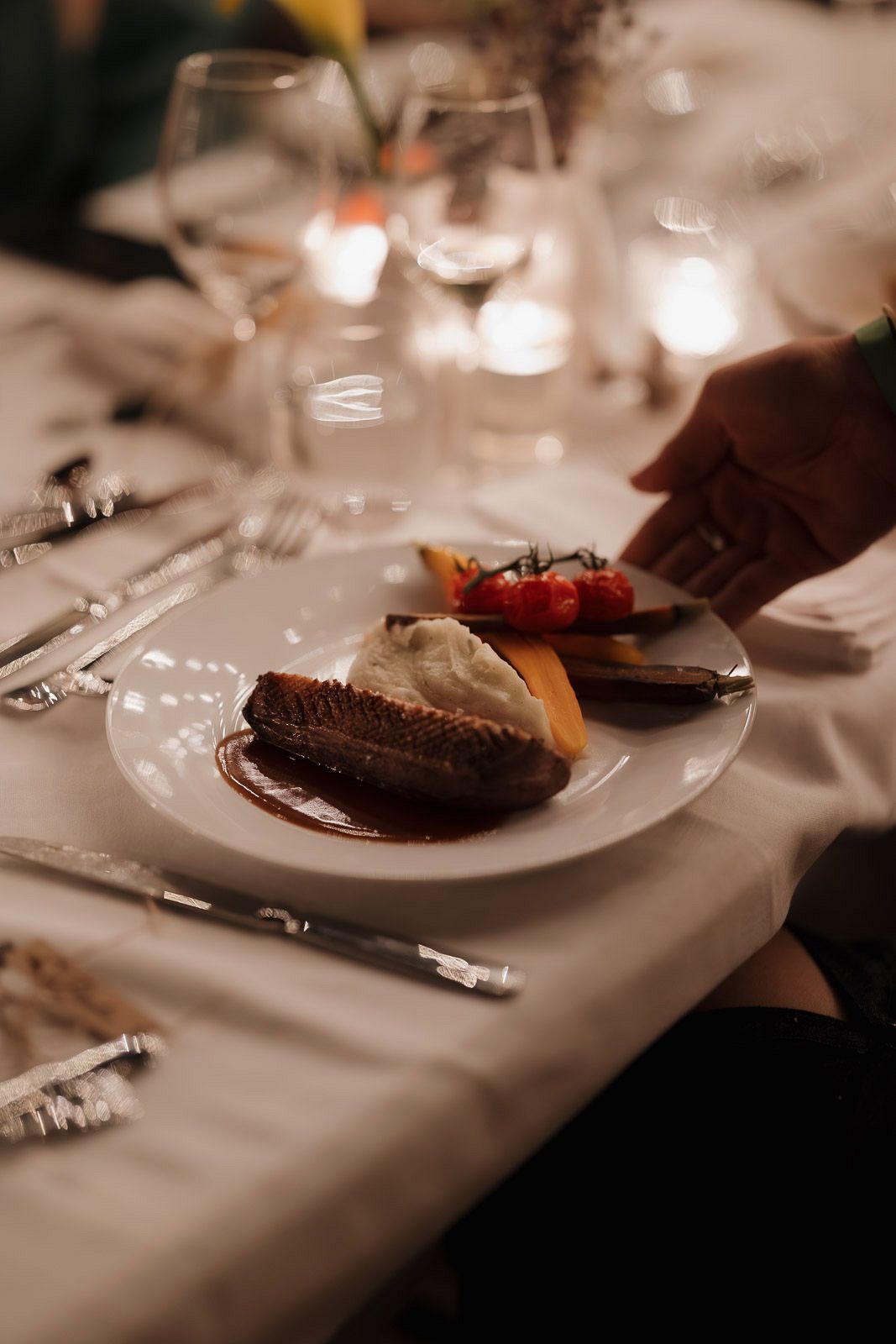 Multiple plates of chocolate desserts served on elegant white dinnerware at an upscale dining table.