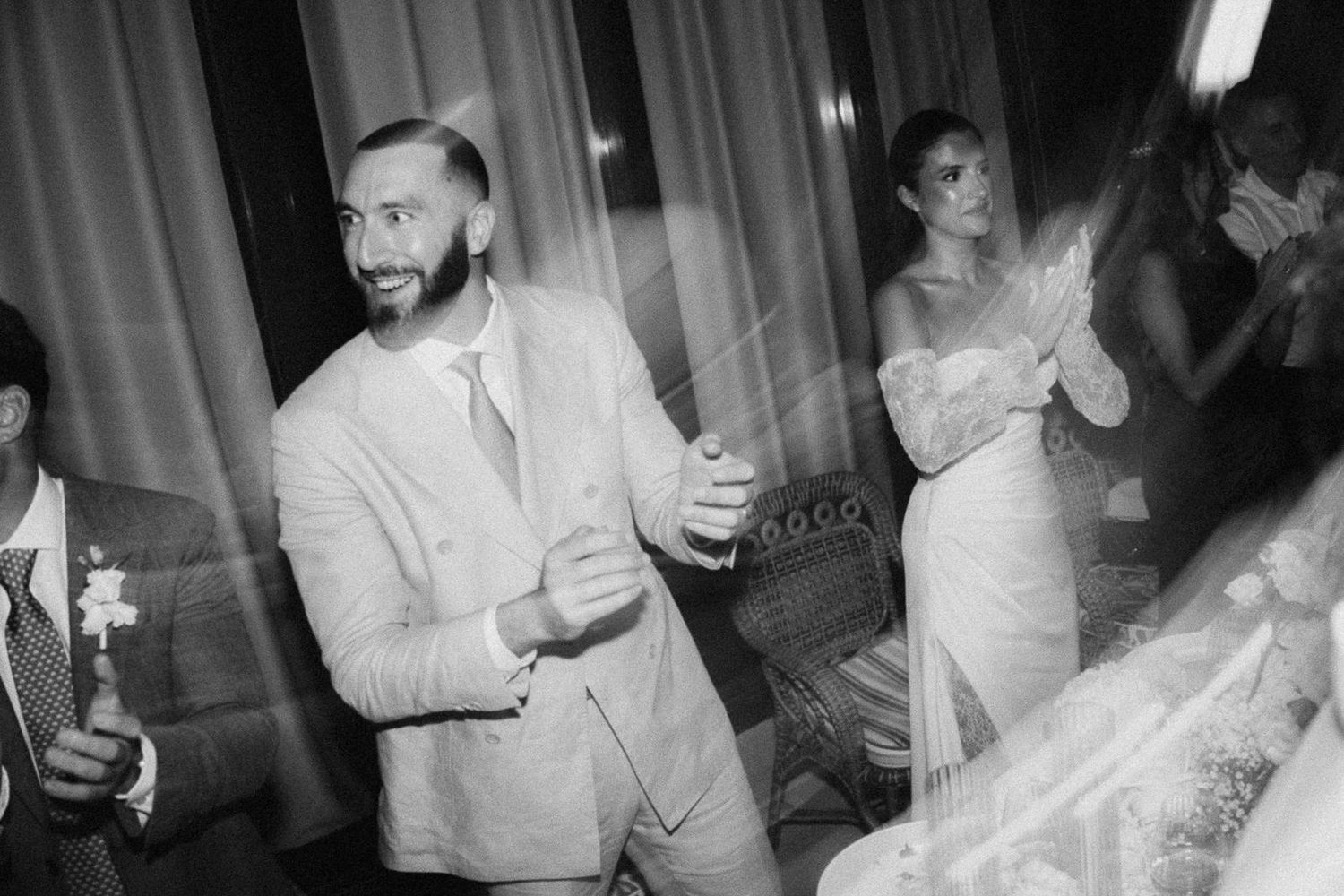 A sequence of black and white party photos showing people dancing and celebrating at what appears to be a wedding reception.