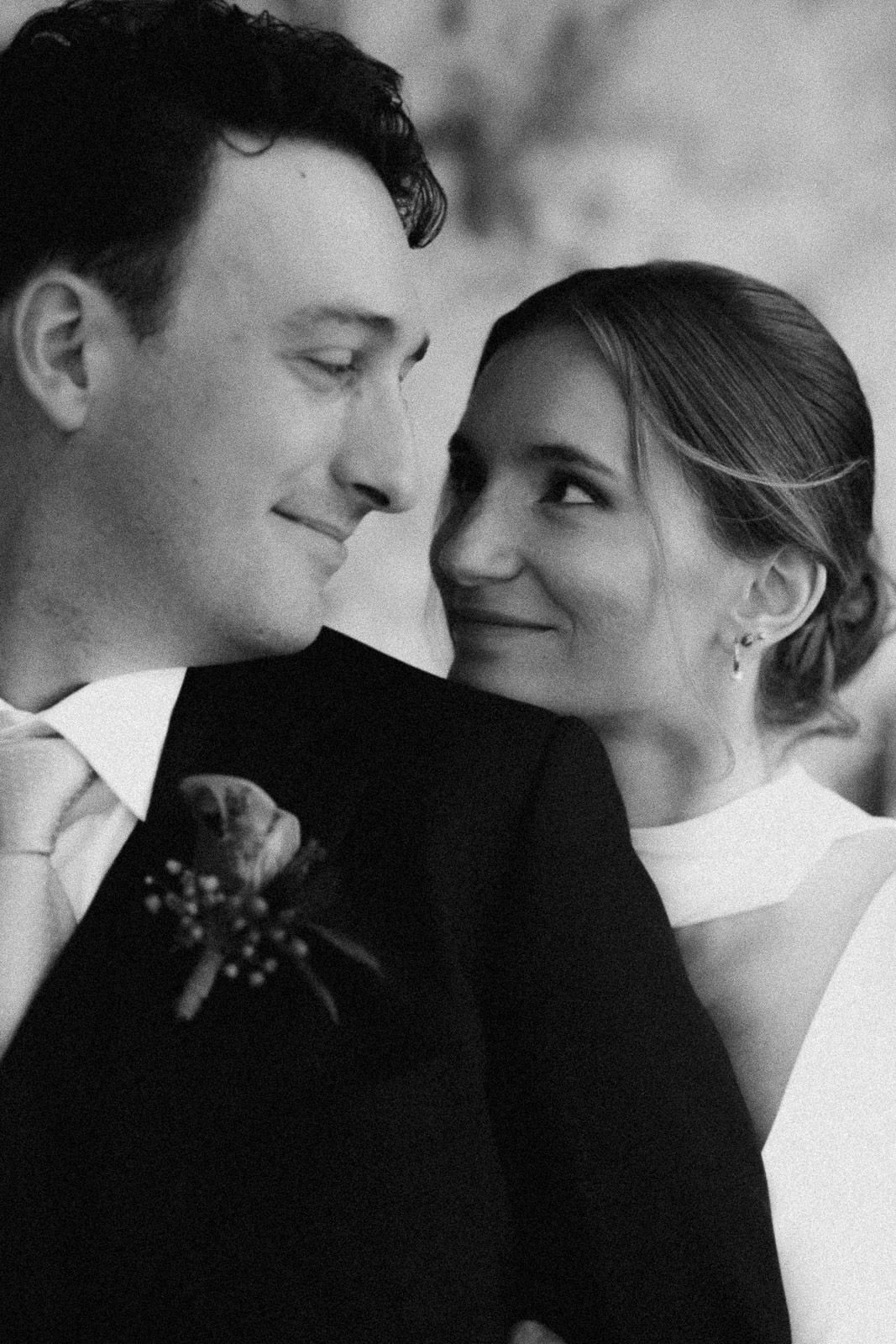 Black and white intimate portrait of a couple on their wedding day sharing a tender moment together.