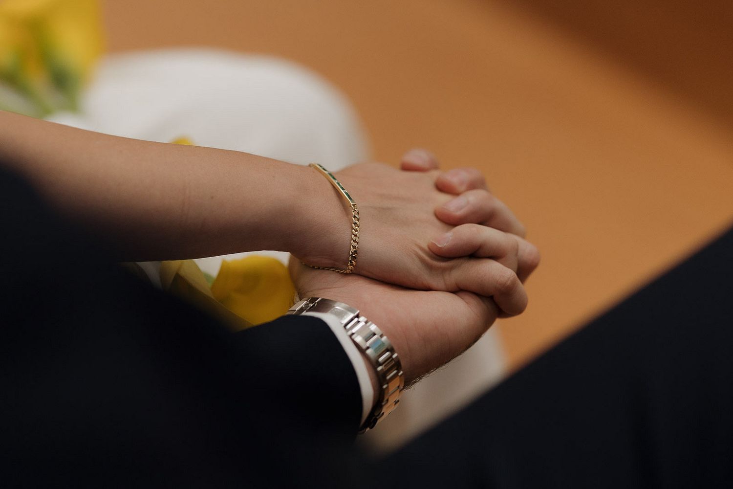 Close-up shot of hands exchanging wedding rings during a traditional ceremony.