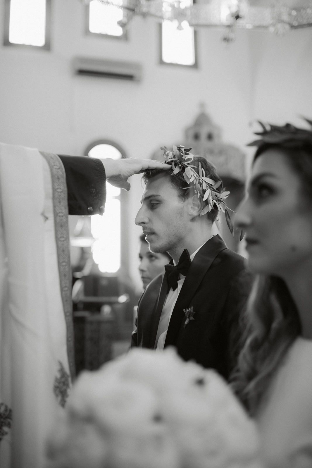 Black and white photograph showing a row of people seated in profile view at what appears to be a formal event.