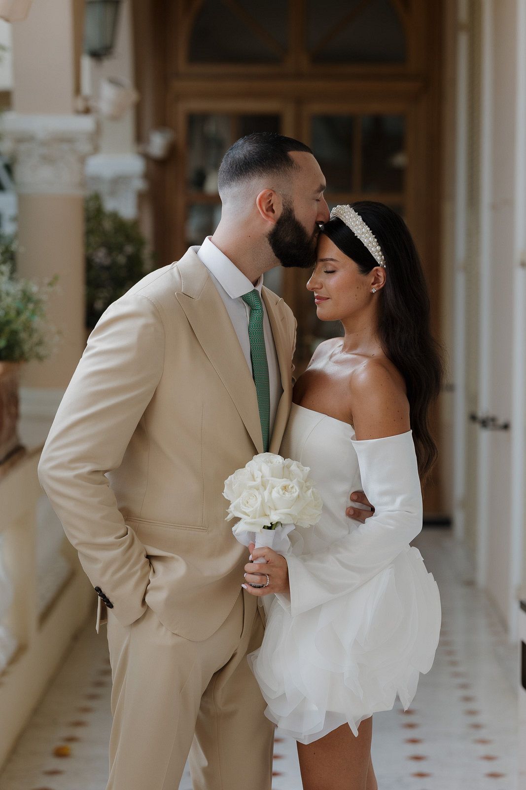 Elegant wedding photography session in a light-filled hallway with classic architectural details.