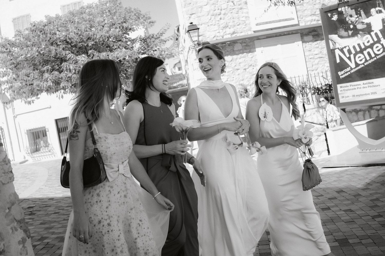 A series of black and white candid wedding photos showing guests and wedding party members celebrating outdoors.