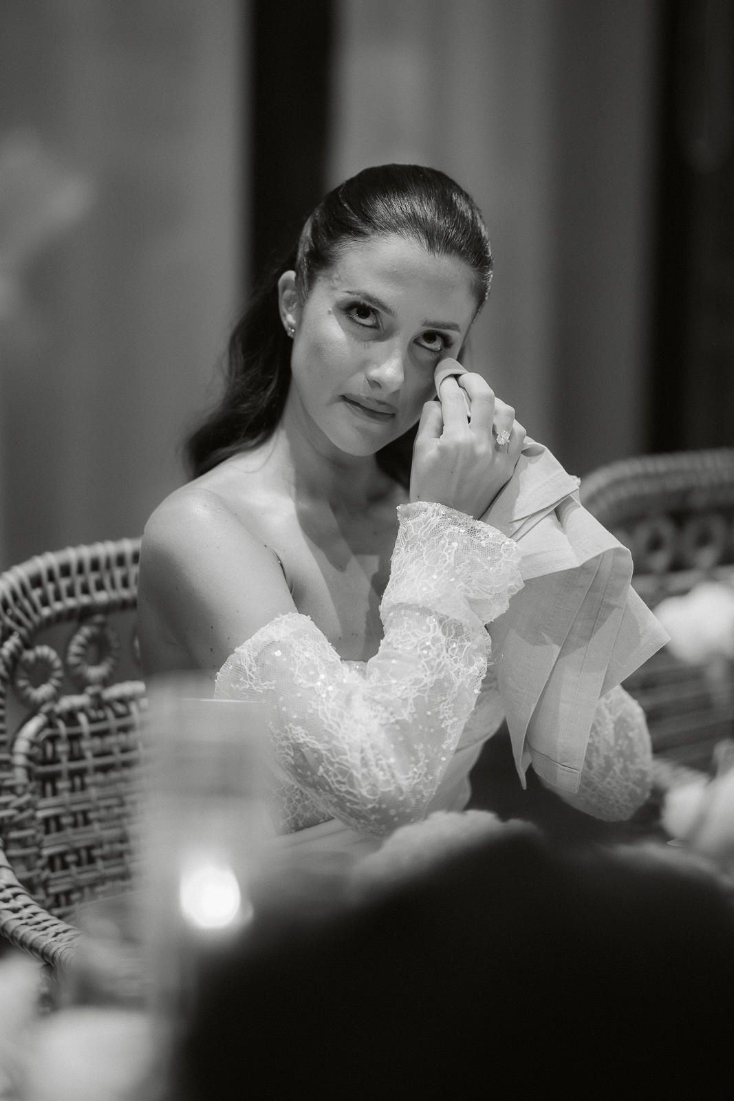 A black and white photo series shows a bride in a white lace dress preparing for her wedding day.