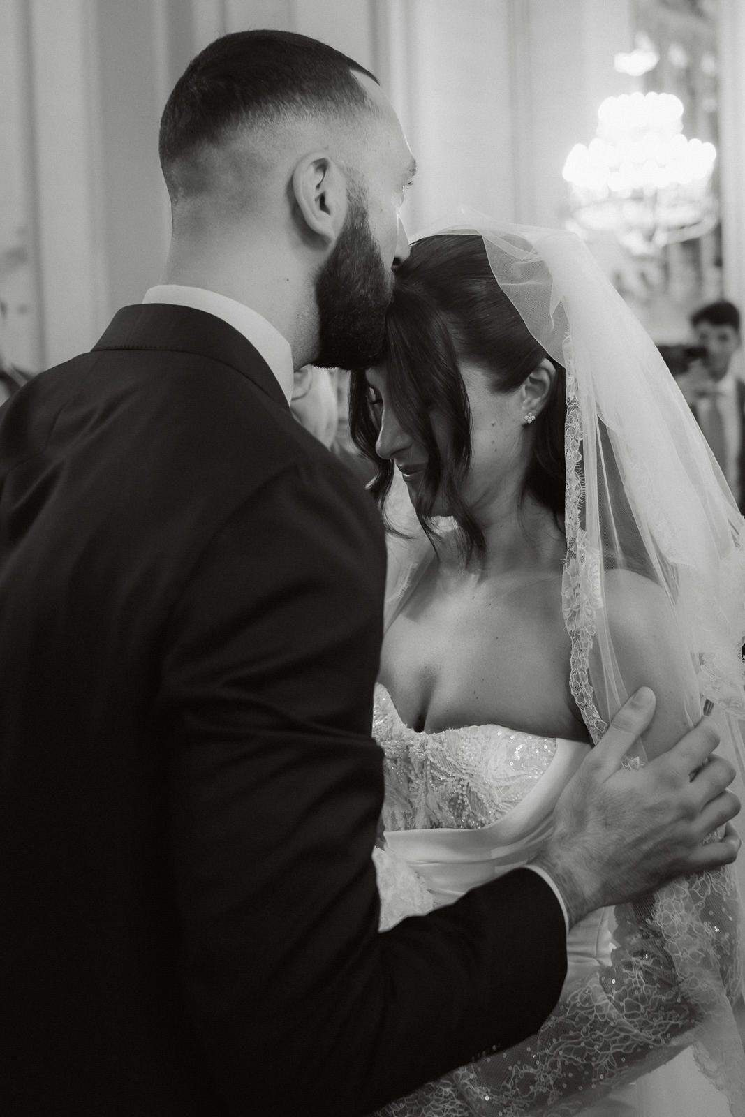 A series of romantic black and white wedding photos showing tender moments between a bride and groom.