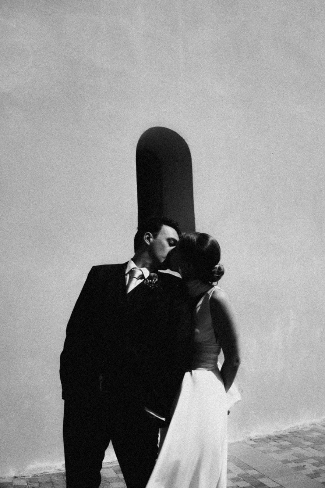 A series of black and white silhouettes showing a couple in formal attire sharing an intimate moment.