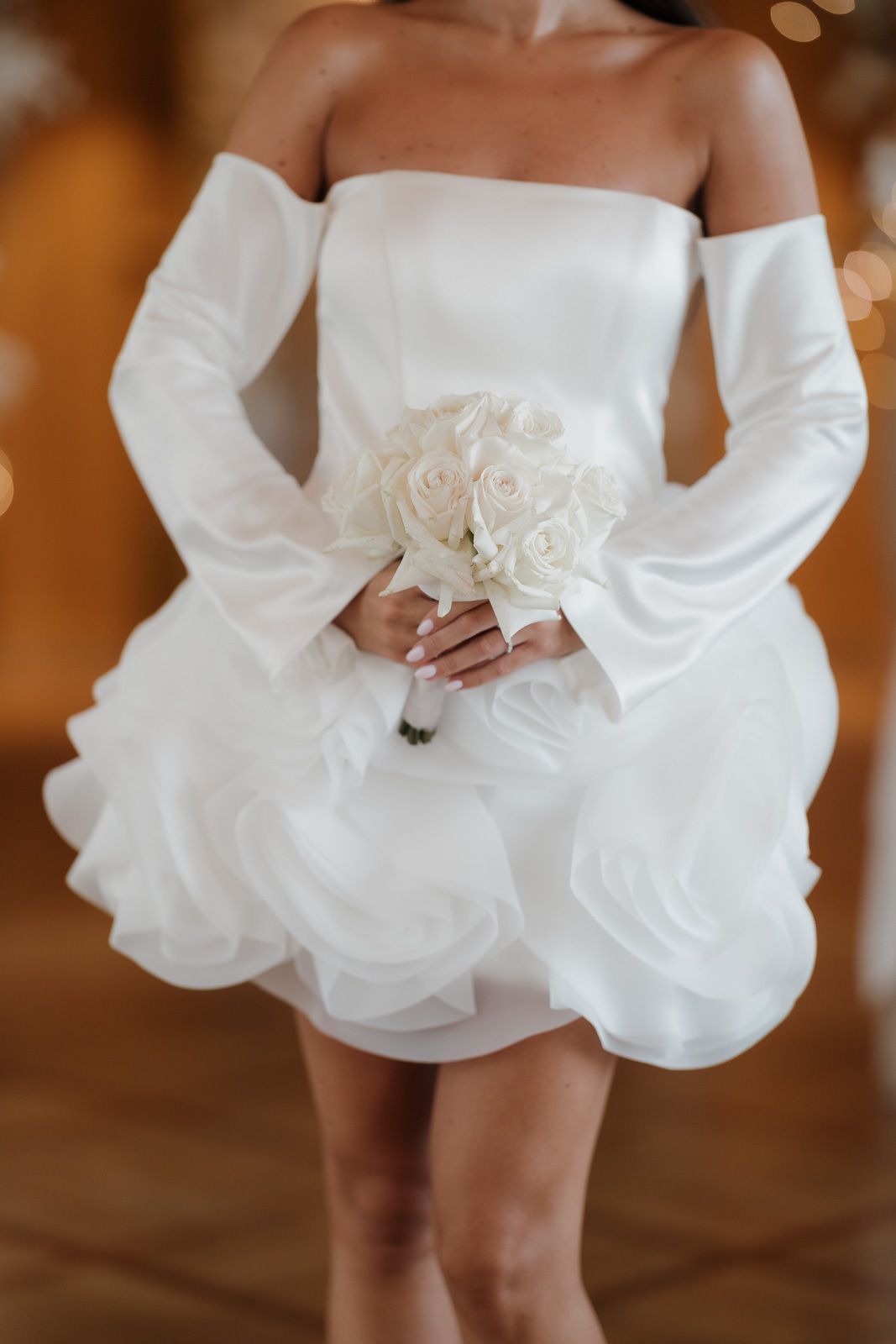 Close-up series of a white wedding dress skirt being twirled, showing its flowing movement and delicate fabric.