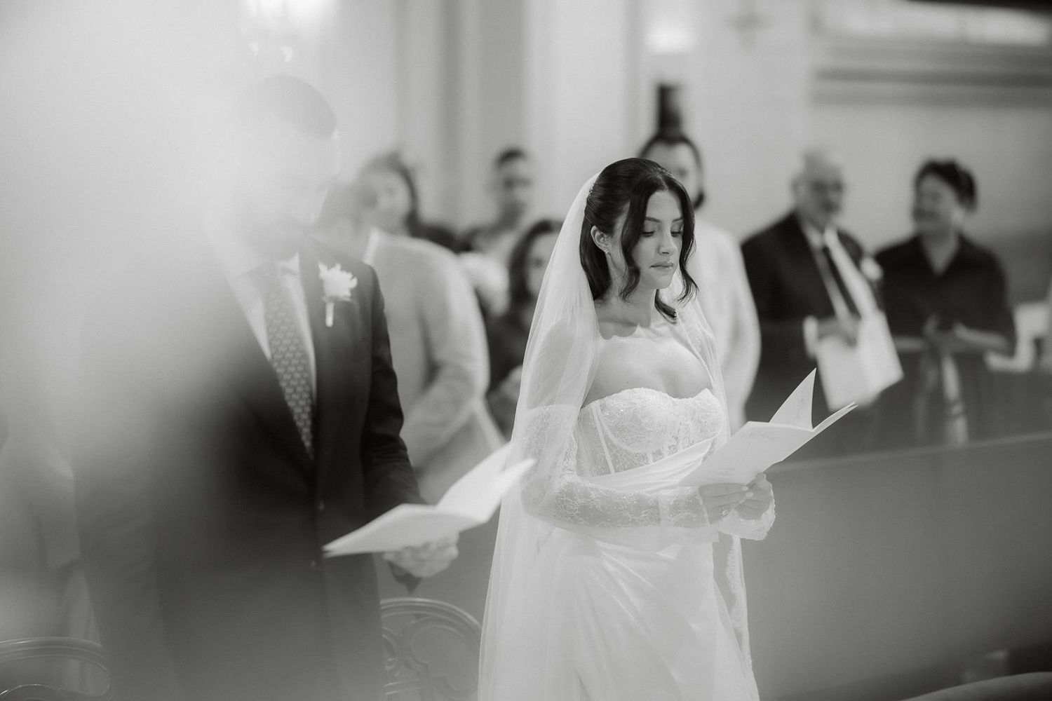 Black and white photo of a couple dancing during their first dance at a wedding reception.