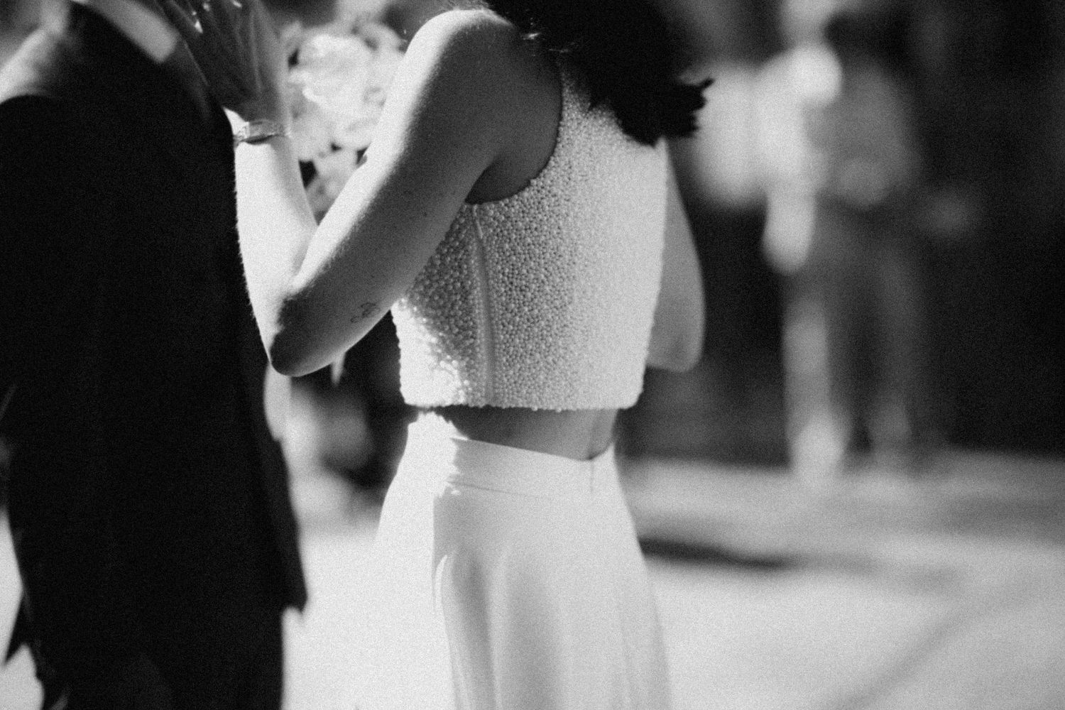 Couple sharing a romantic dance in black and white wedding photo.