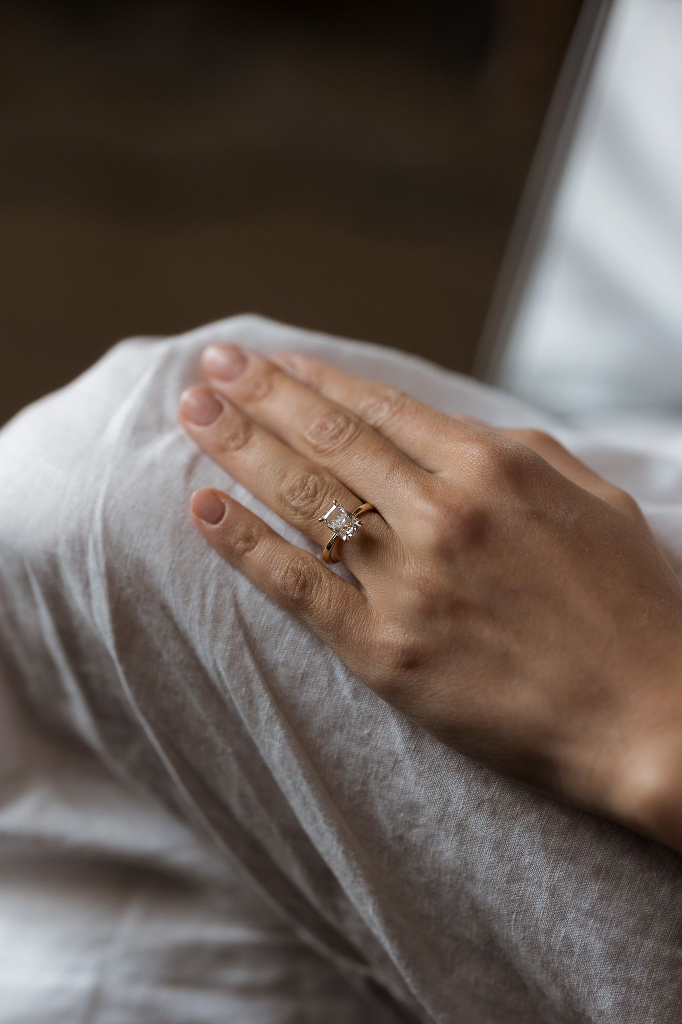 Close-up of a elegant diamond engagement ring and wedding band on a bride's hand.