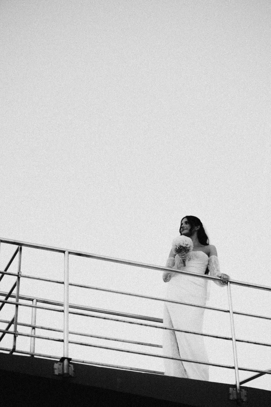 A minimalist black and white photo series showing a figure ascending stairs with a handrail against a white background.