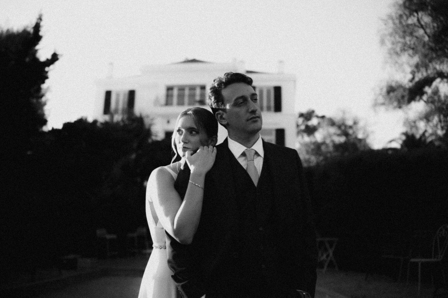 A black and white wedding photo collage showing intimate moments between a couple during their special day.