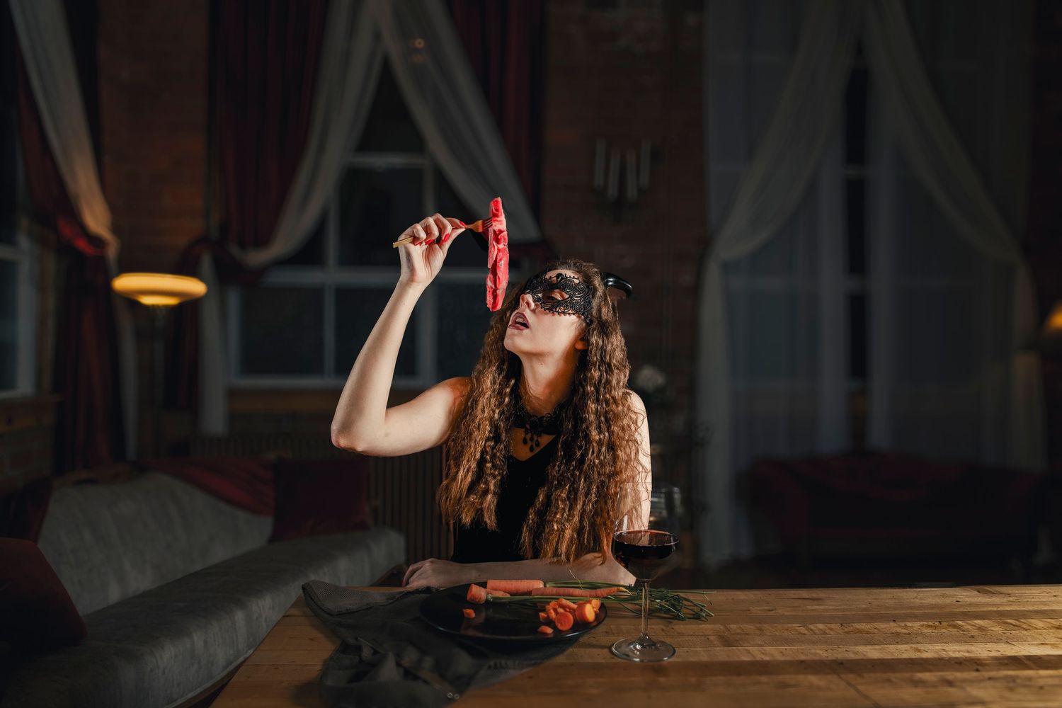 Atmospheric photo of figure drinking red liquid in dimly lit room with vintage decor.