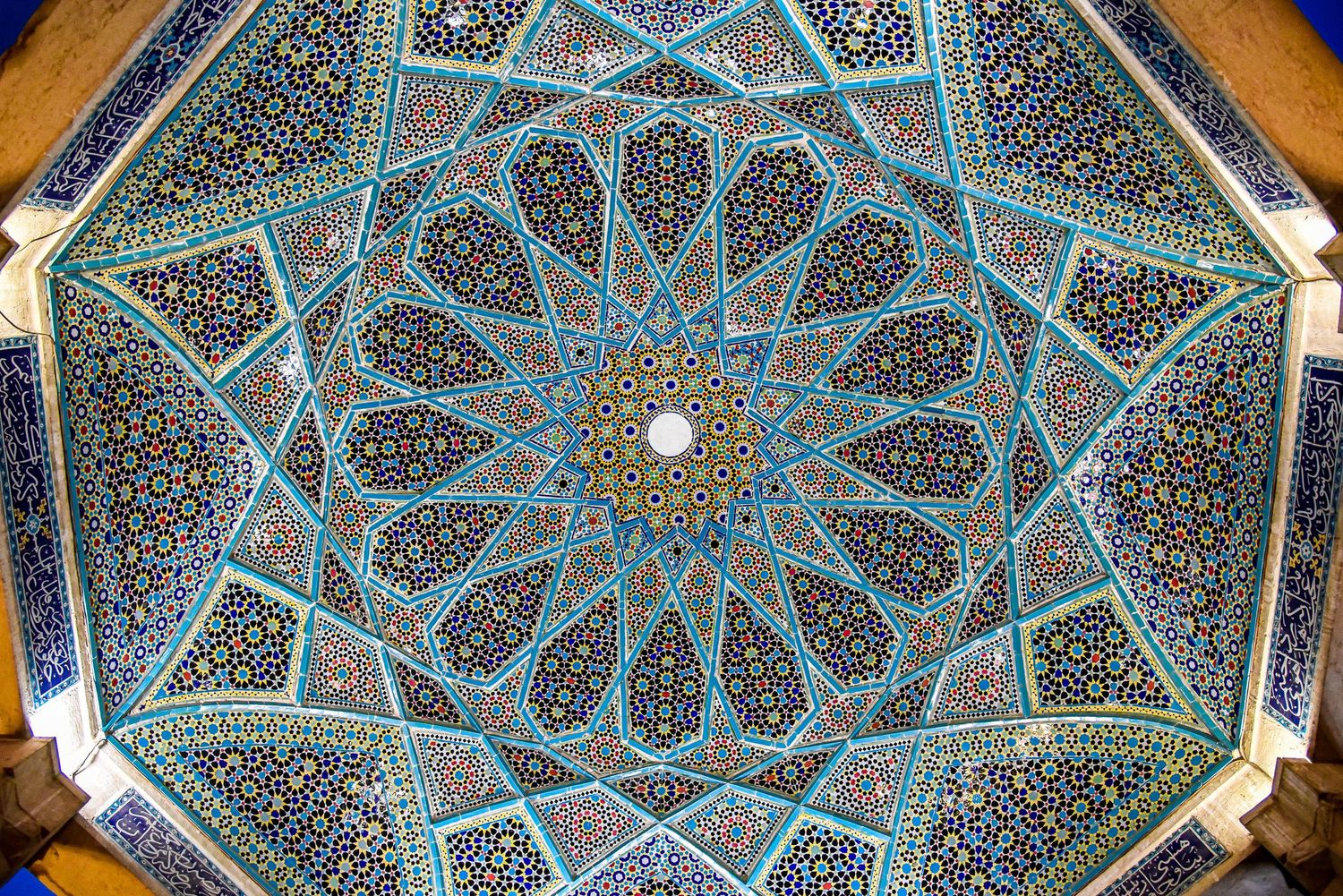 Stunning blue mosque dome ceiling with intricate geometric patterns radiating from central star design.