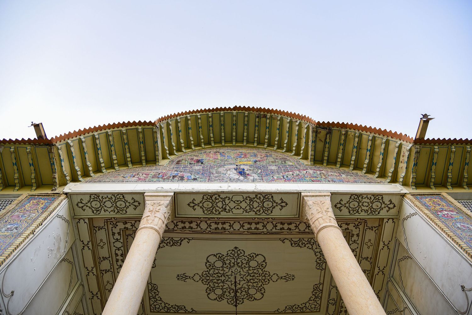 Intricate architectural detail of an ornate ceiling with geometric patterns and wooden railings.