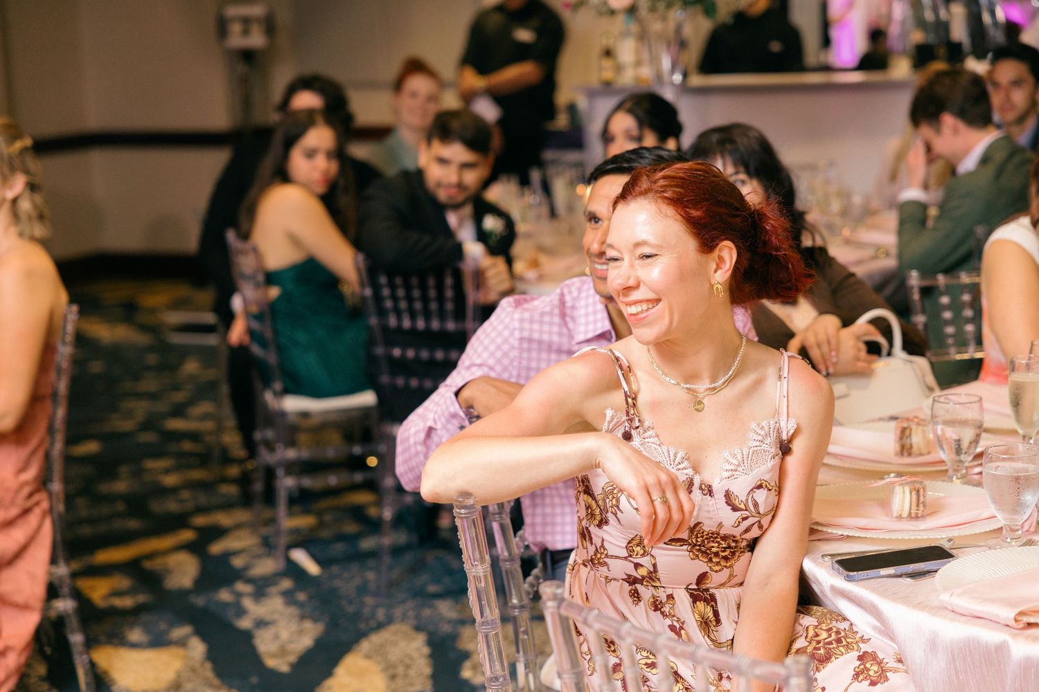 Wedding guests enjoying themselves at an elegantly decorated reception venue.