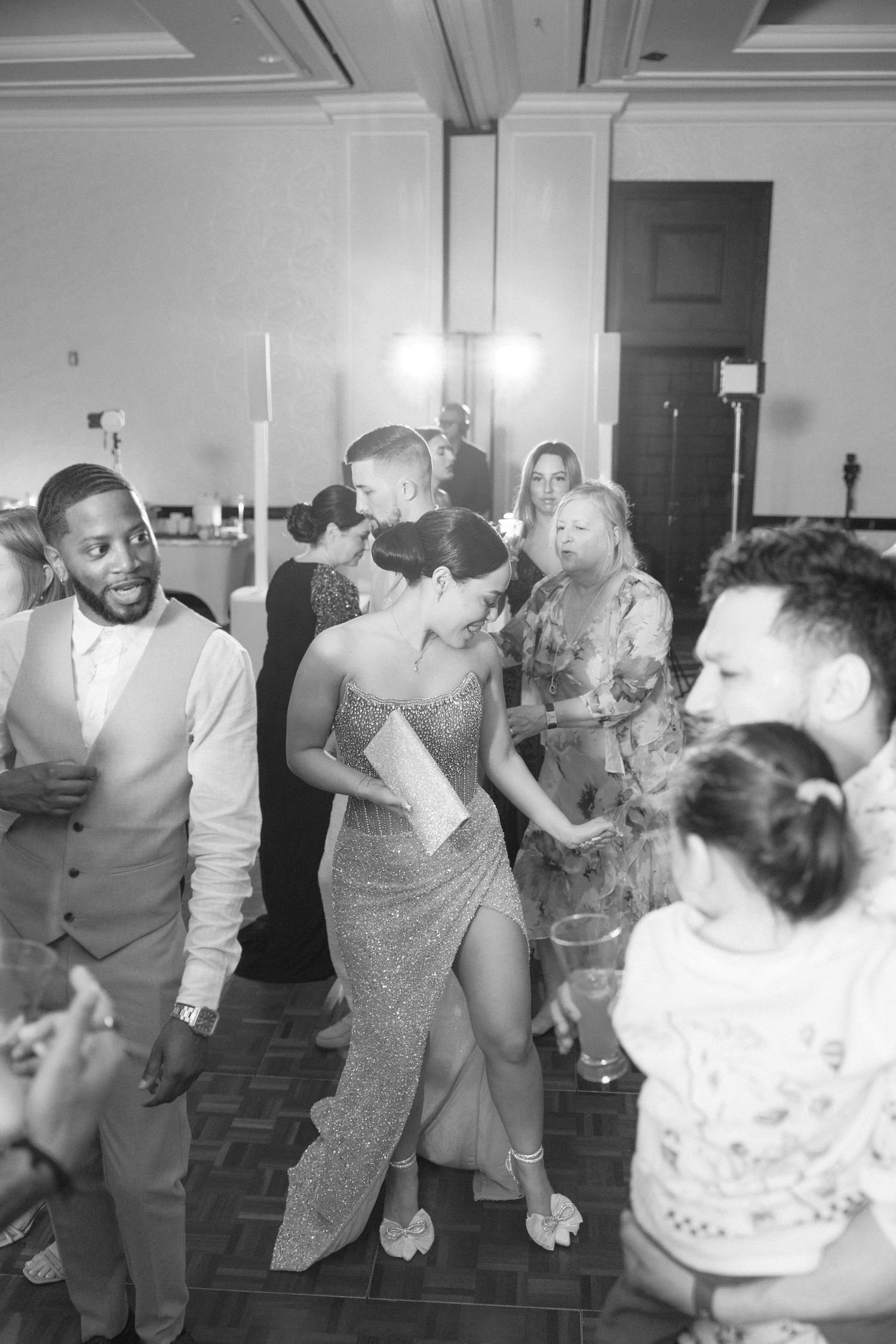 Wedding guests dancing and celebrating on the reception dance floor.