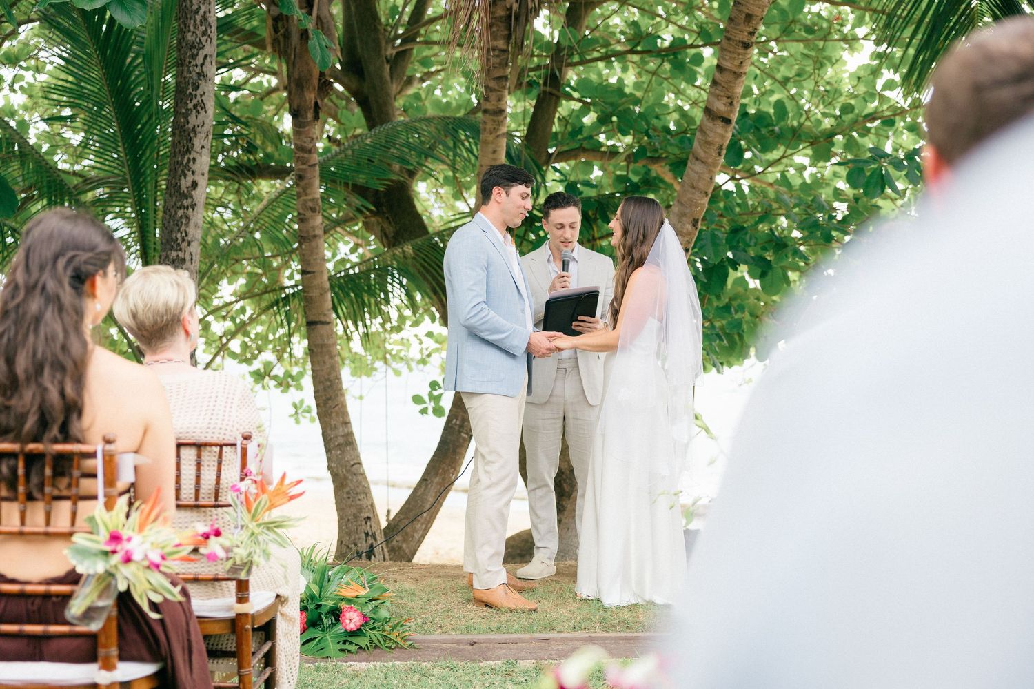 Garden wedding ceremony setup with trees and natural lighting.