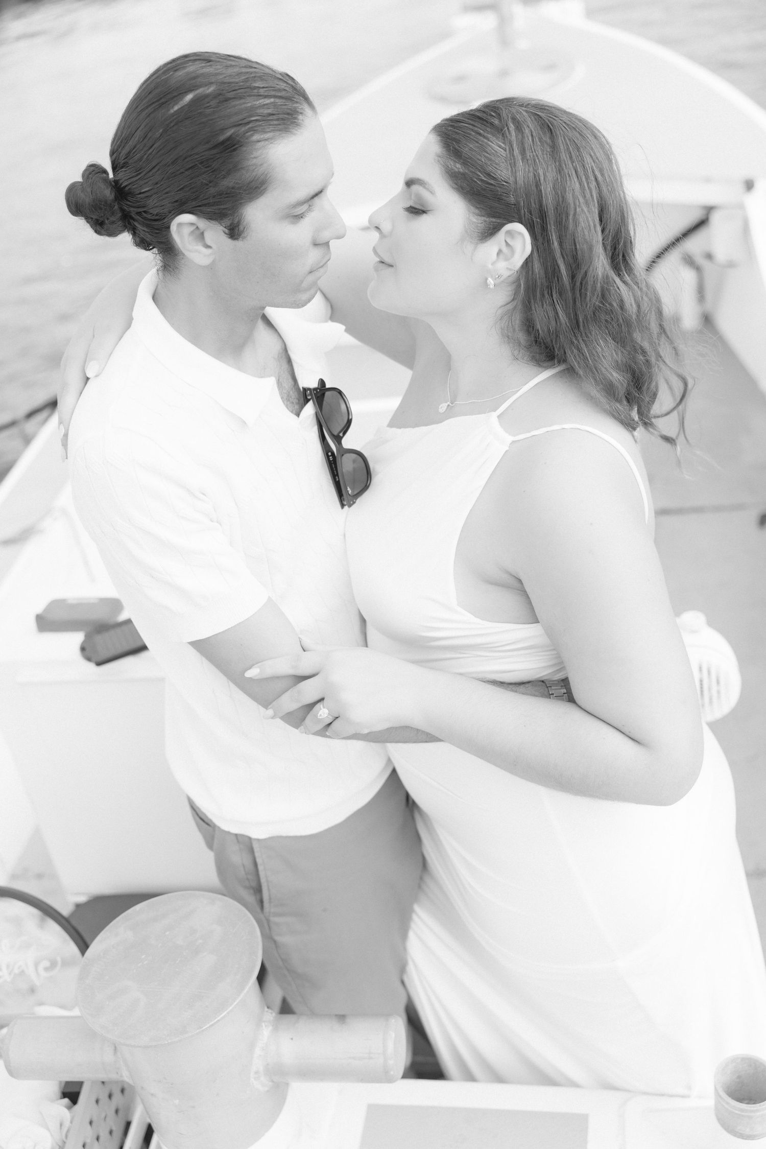 A romantic black and white photo series showing tender moments between a couple in white attire.