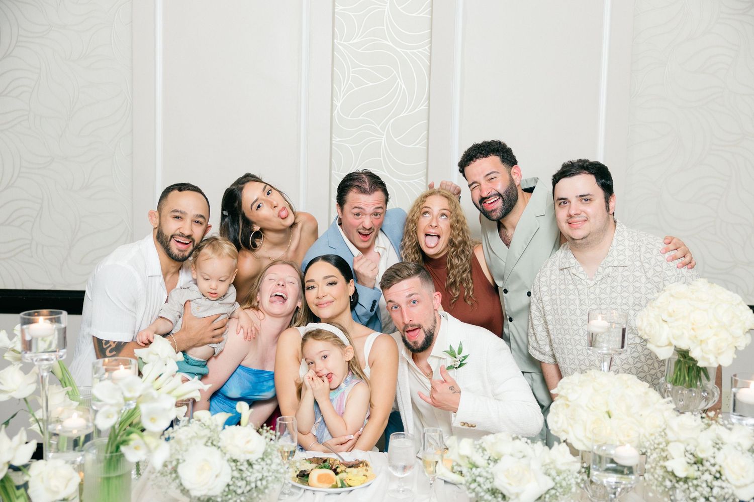 Candid moments of wedding party and guests celebrating at decorated reception table.