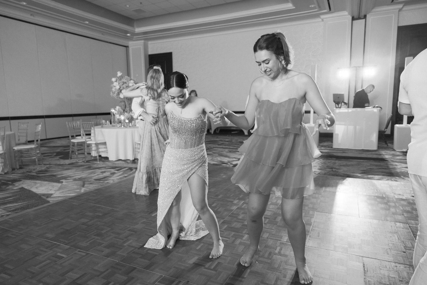 Couples dancing together during a festive wedding reception celebration.