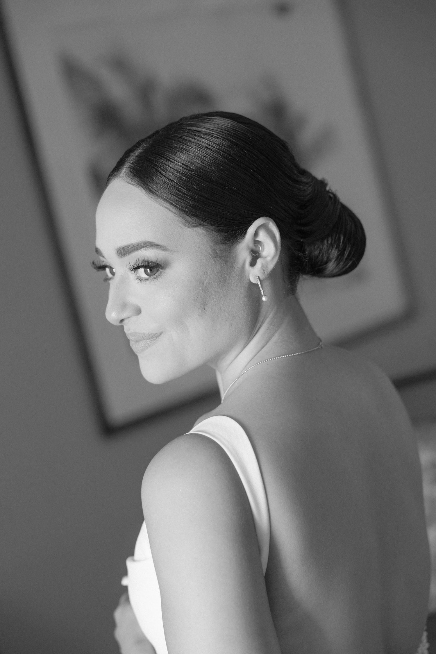 Elegant black and white portraits showing sleek updo hairstyle and formal attire.