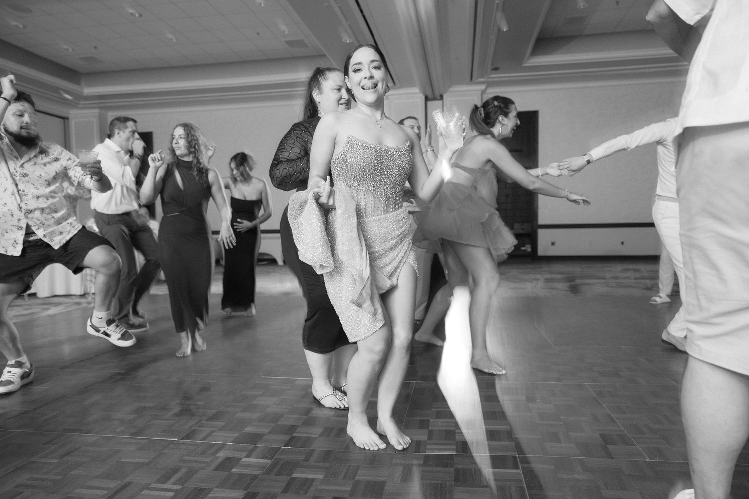 People dancing in a line at a wedding reception.
