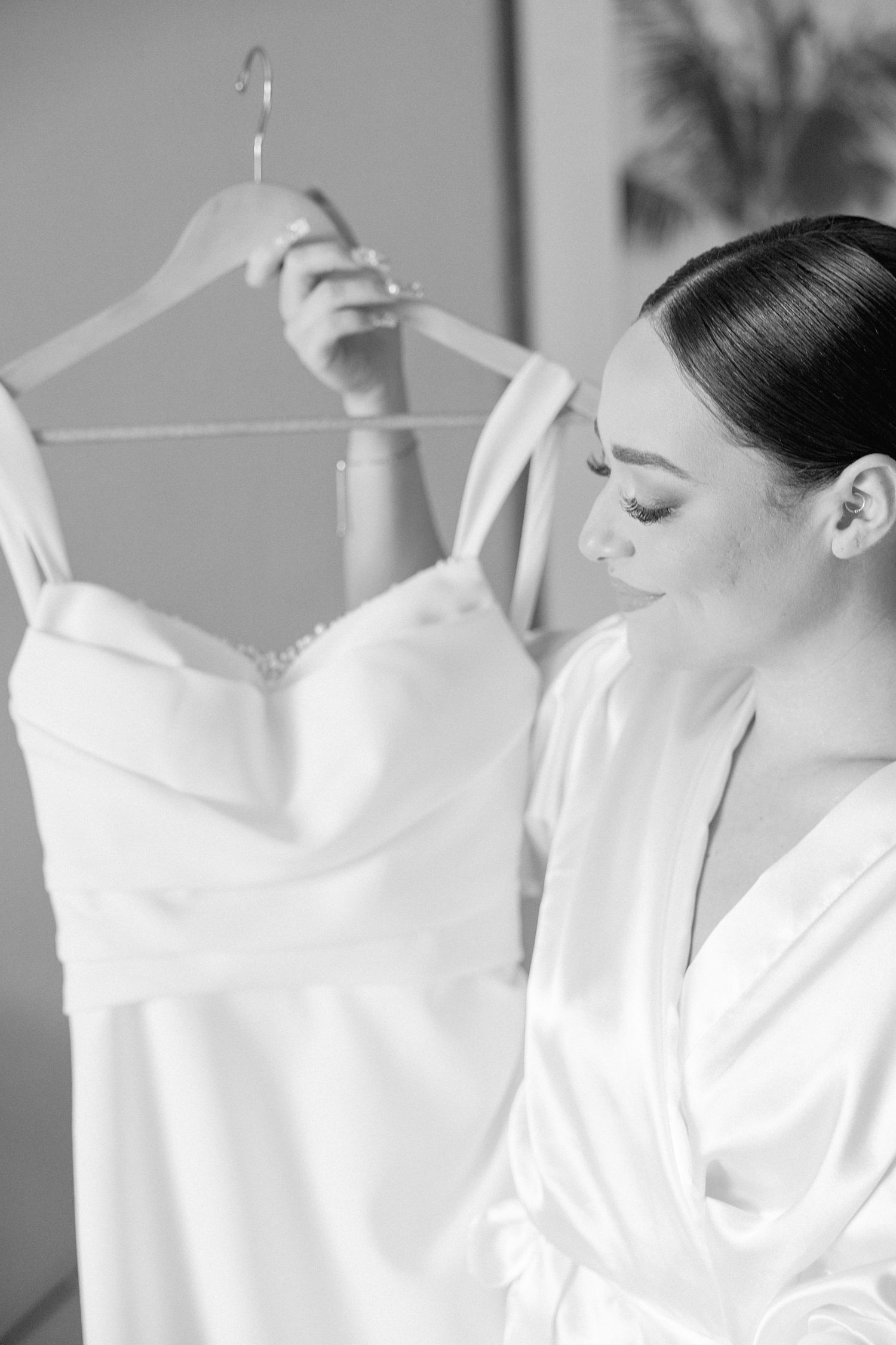 Series of white wedding dress preparation shots in soft focus.