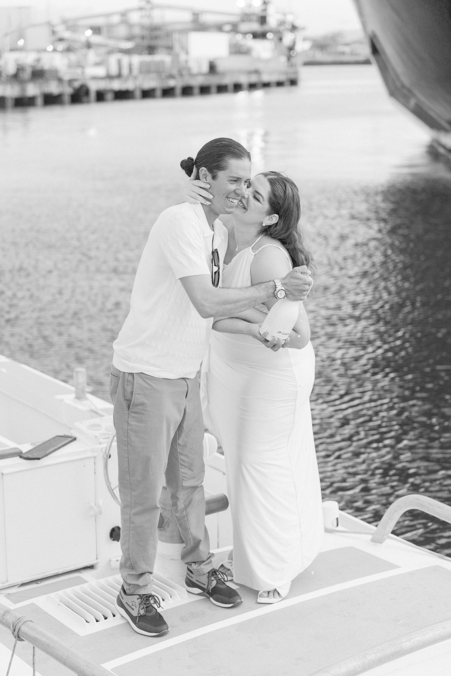 Romantic couple relaxing together on a white boat deck.