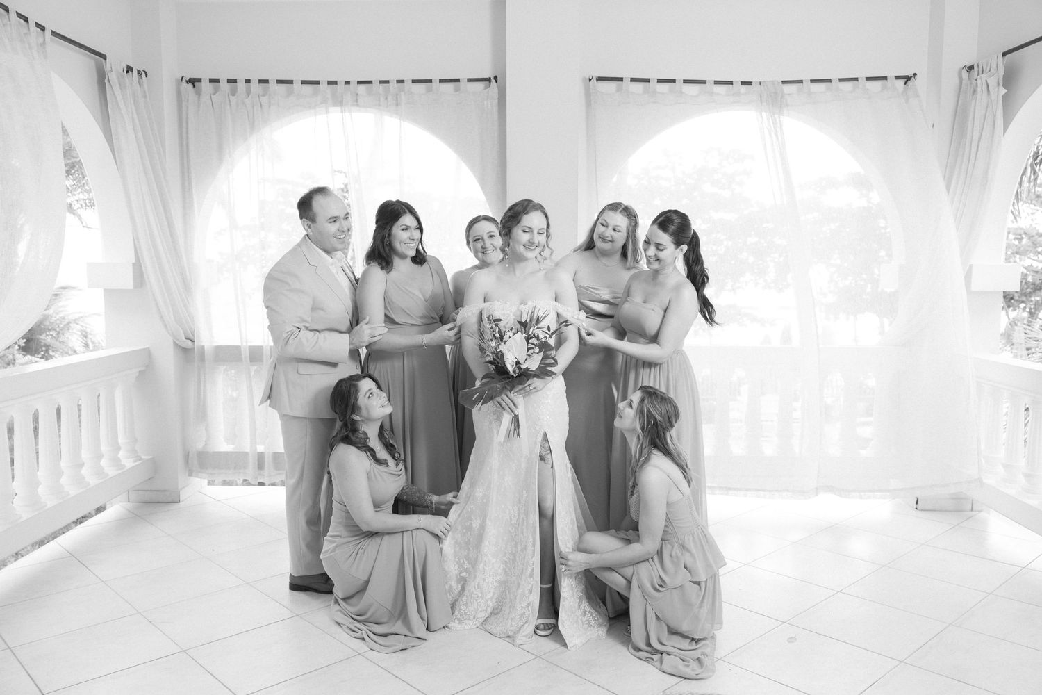 Classic black and white portrait of bridal party in an elegant white gazebo setting.