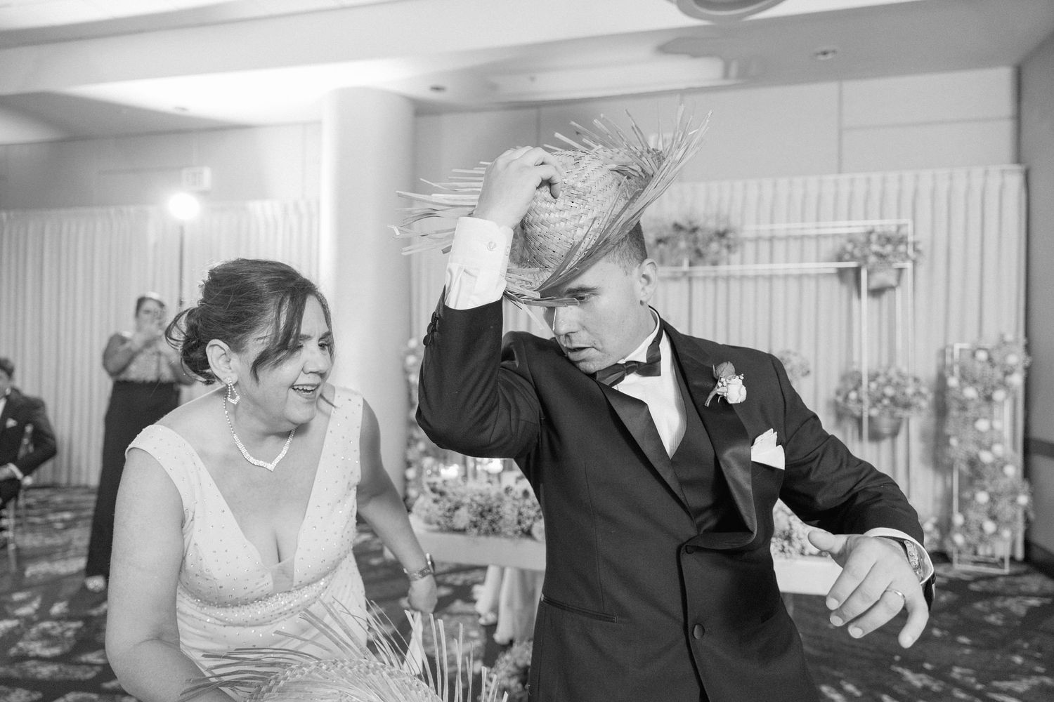 Wedding party members share laughs and dance moves during reception celebration.
