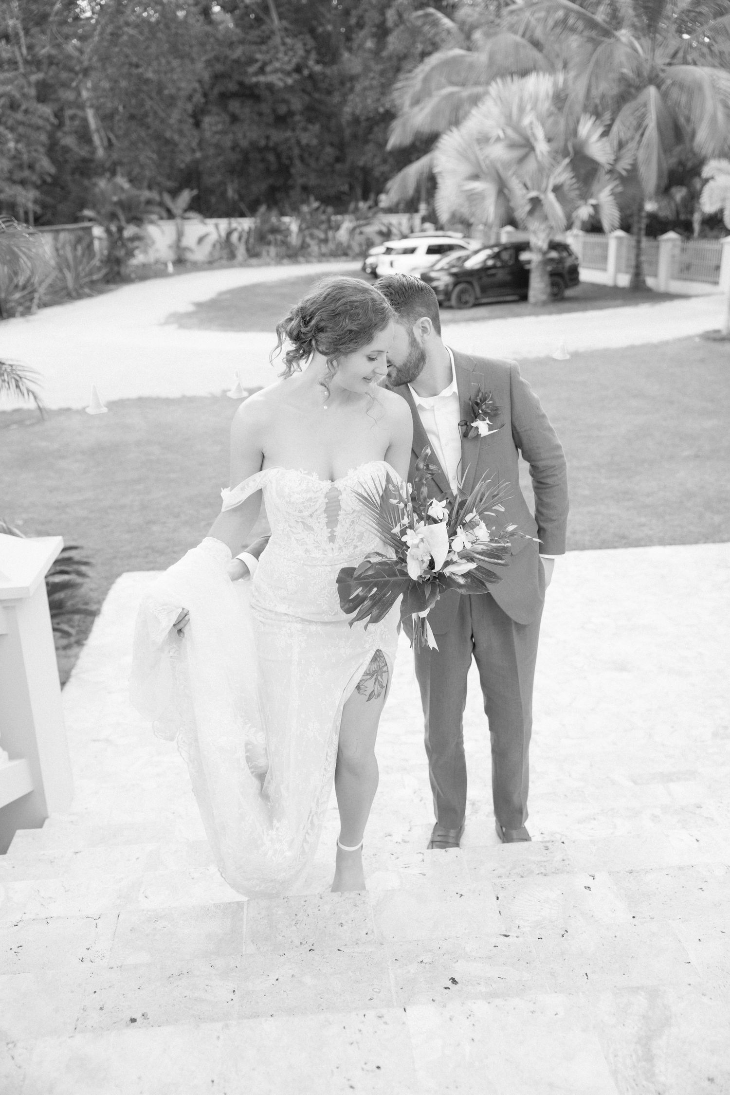 Black and white wedding photos showing playful moments in an outdoor garden setting.