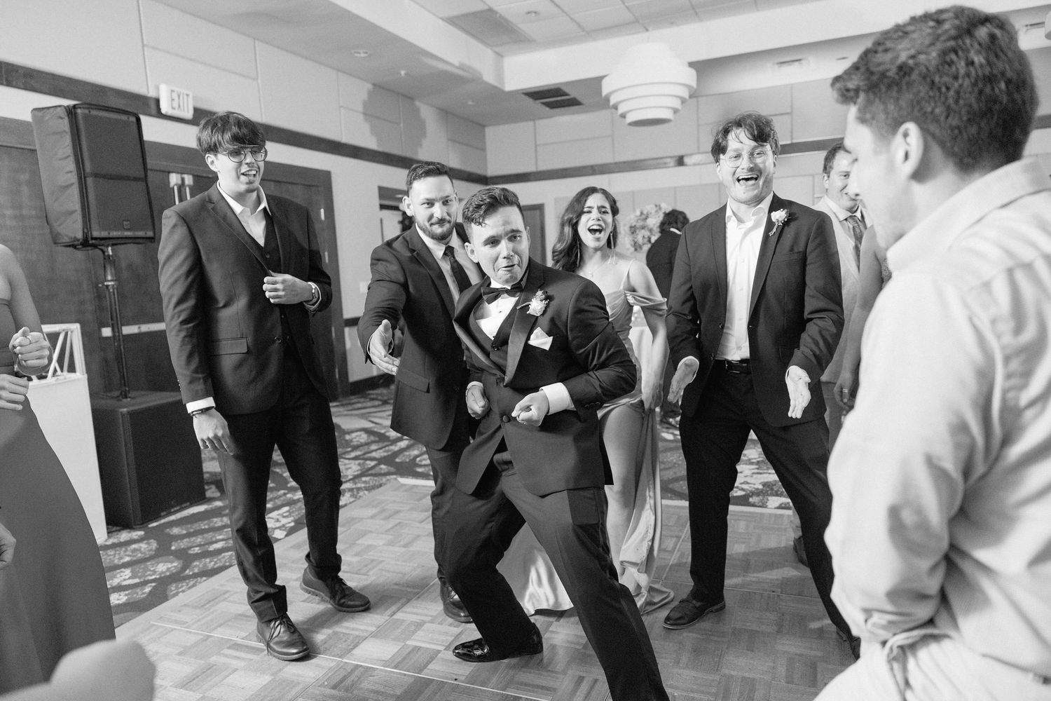 Wedding guests dancing in formation during a choreographed dance number.