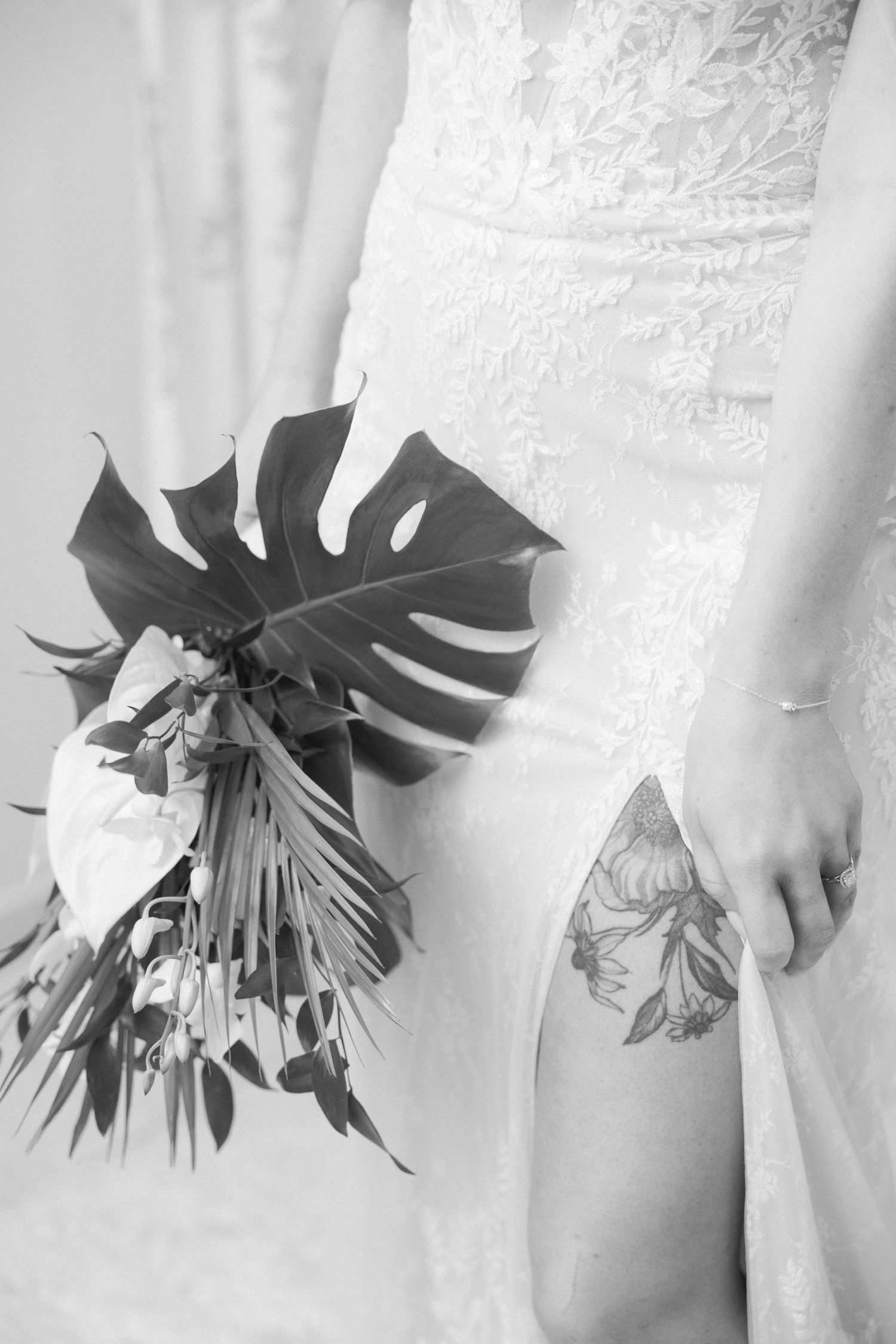 Black and white detail shots of monstera leaves against white wedding dress fabric.