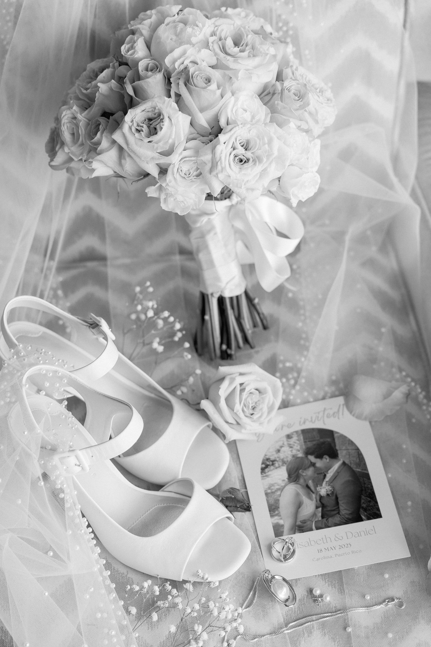 White bridal shoes and bouquet arranged with wedding details in soft focus.