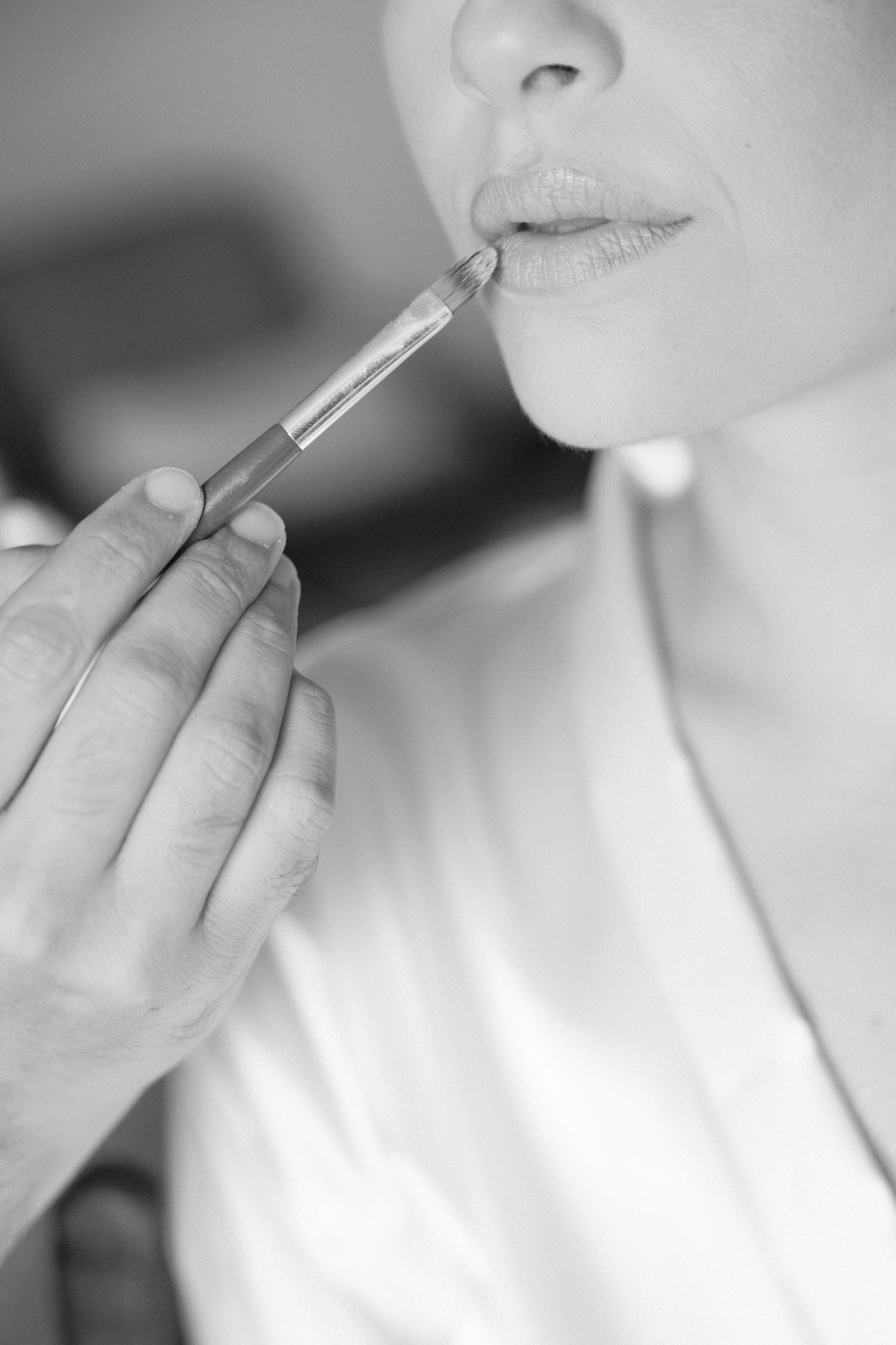 Close-up shots of lip gloss application during bridal makeup.