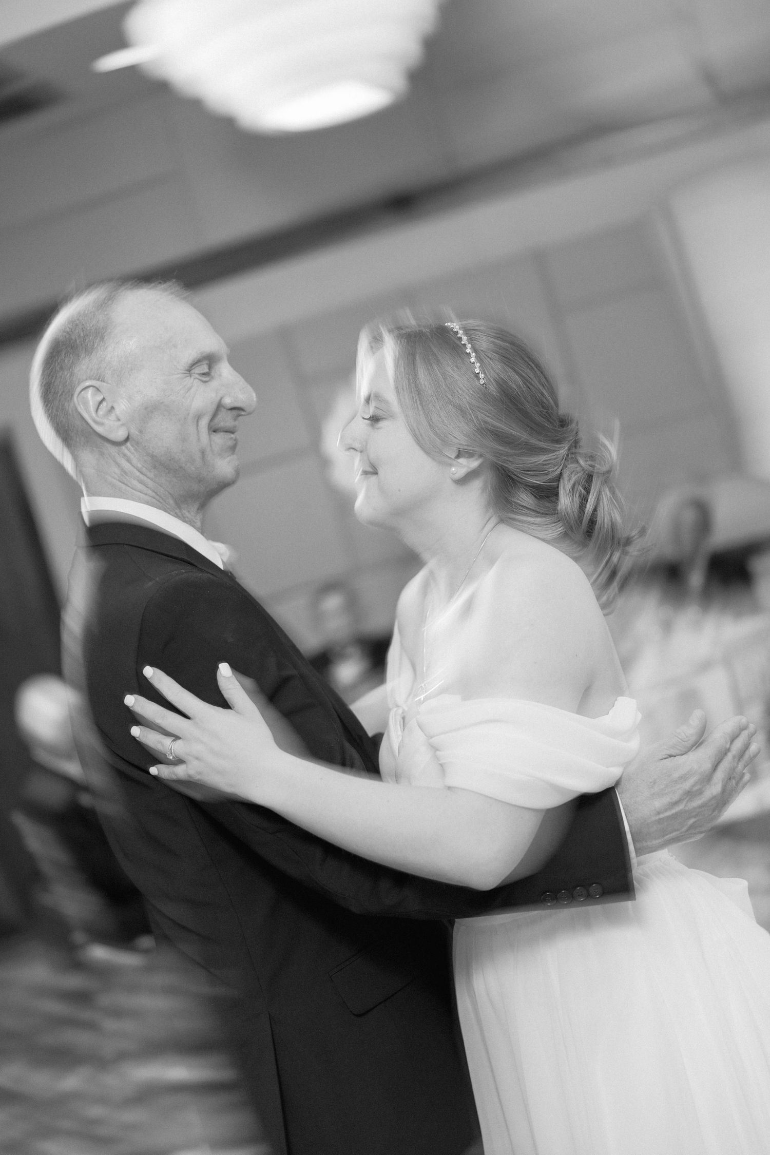 Intimate black and white photo capturing a joyful dance at a wedding celebration.