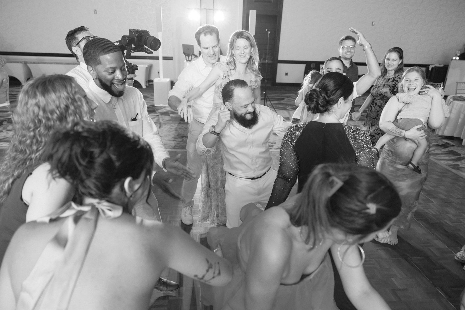 People enjoying themselves while dancing at a lively wedding reception party.