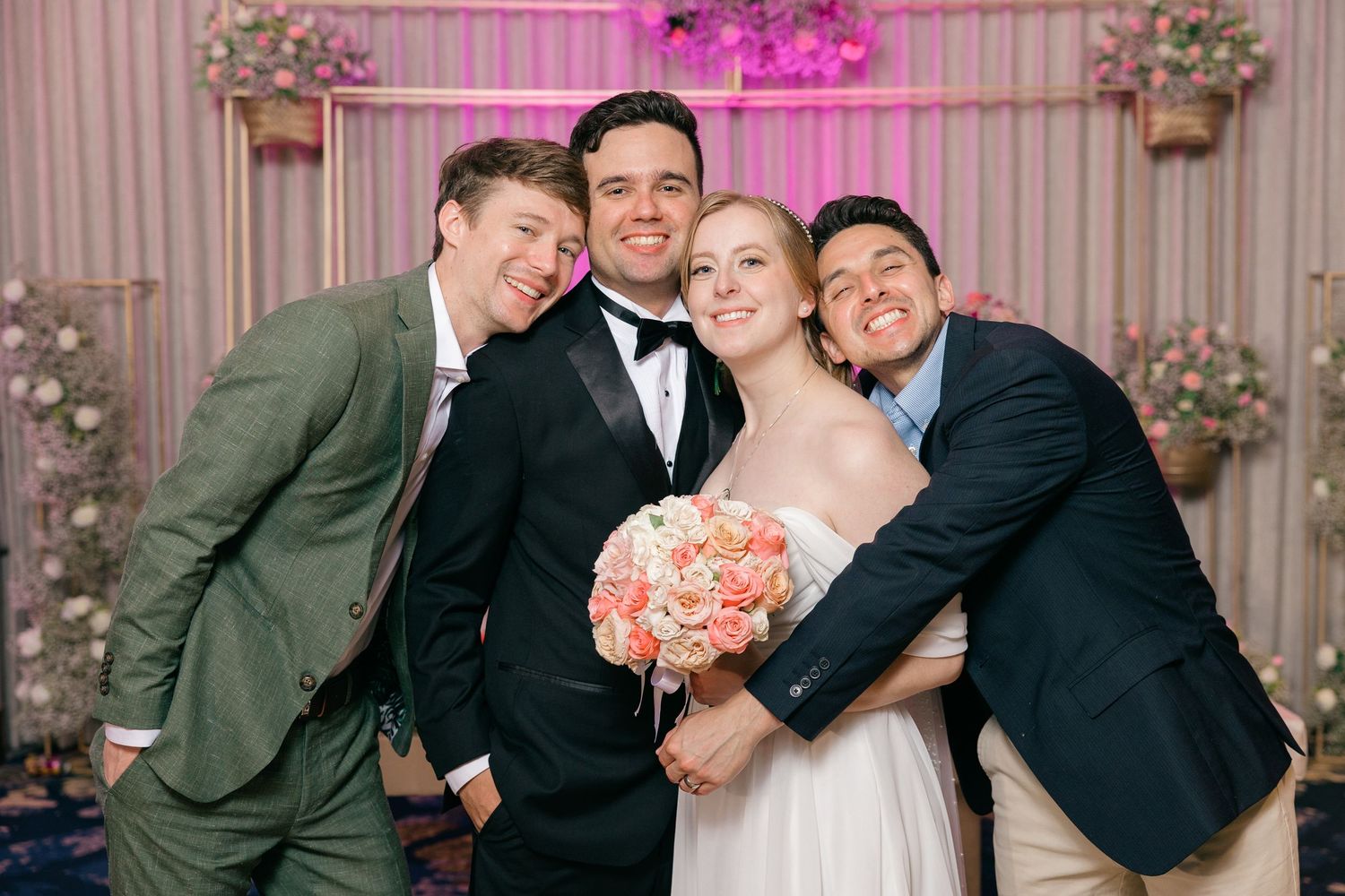 Fun wedding party photo with groomsmen in different colored suits.