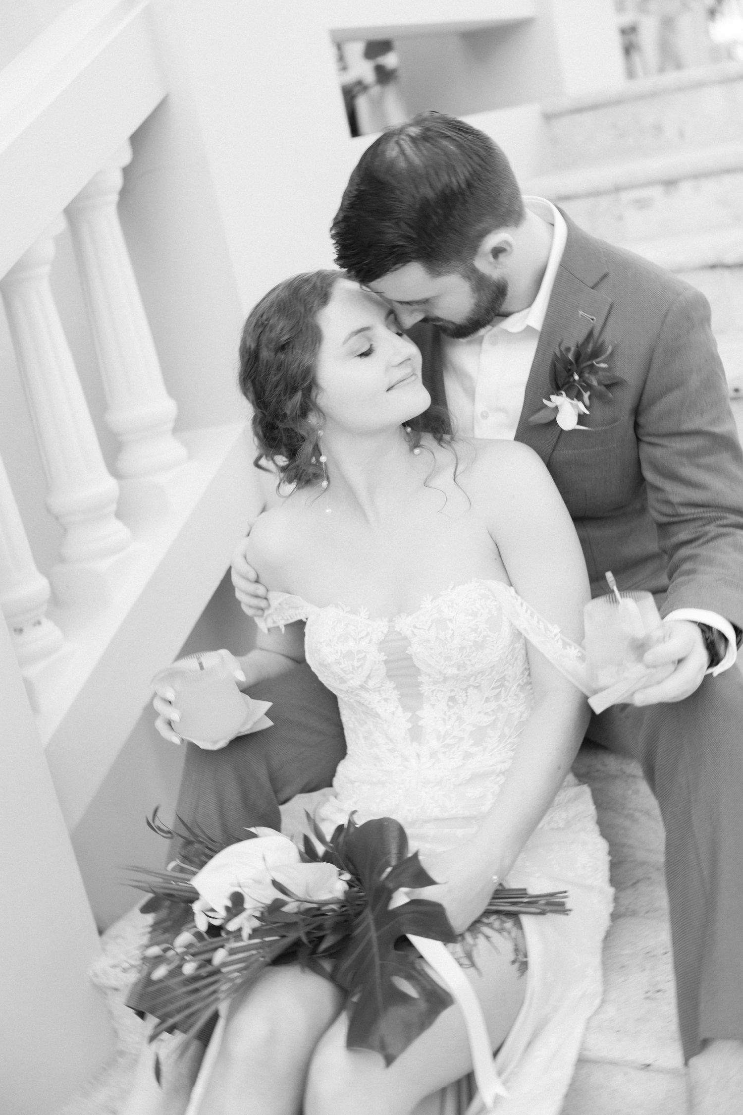 Intimate black and white wedding portraits showcase tender moments between newlyweds.