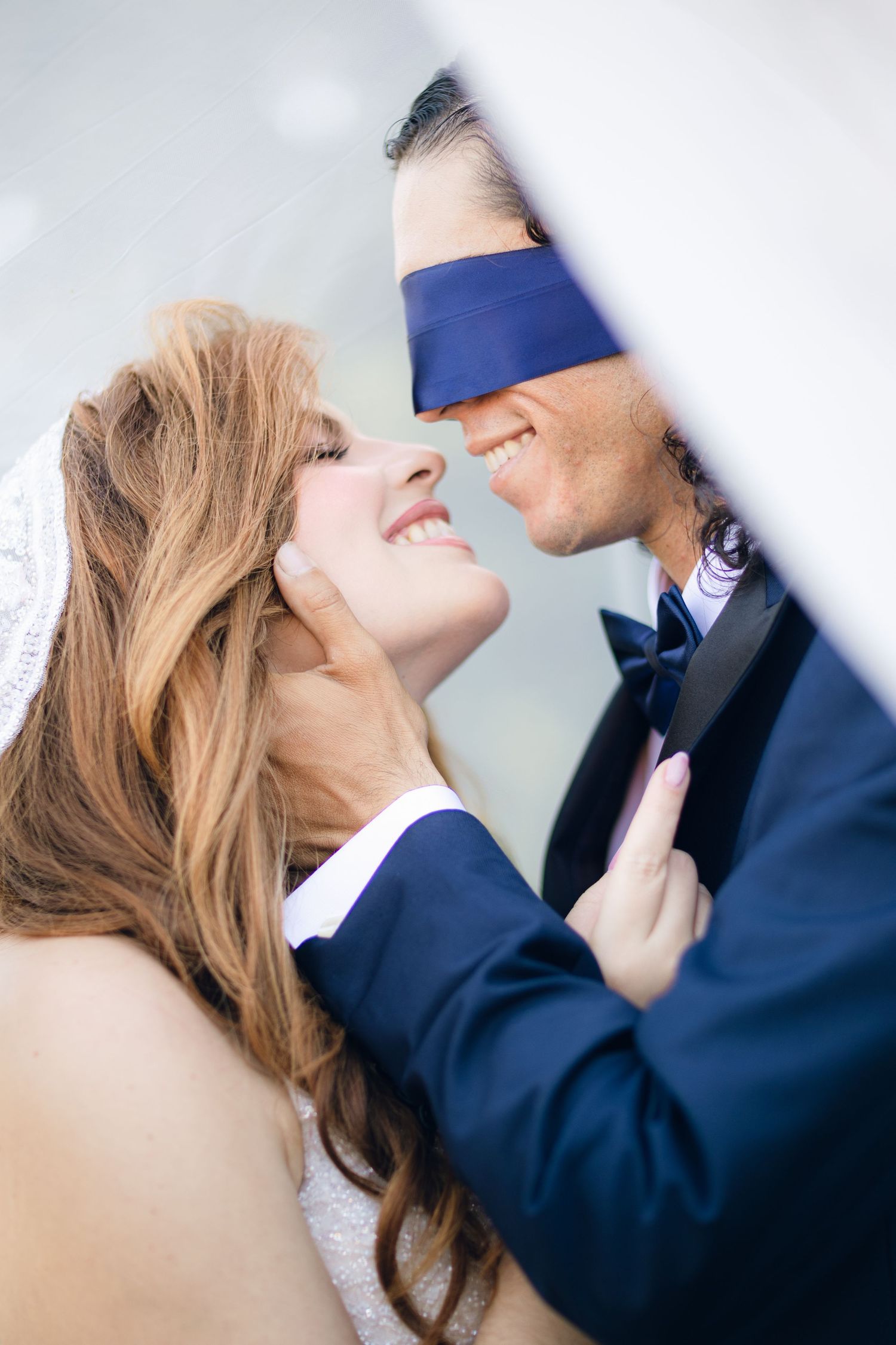 Close-up artistic wedding photo showing tender moment between newlyweds.