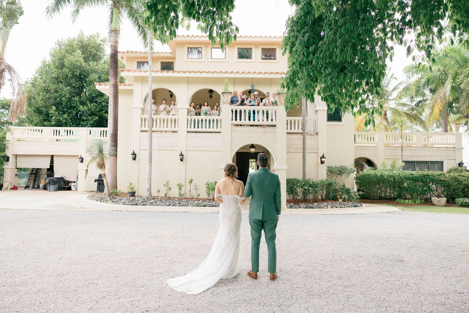 Mediterranean-style venue with palm trees and arched architecture for outdoor wedding.