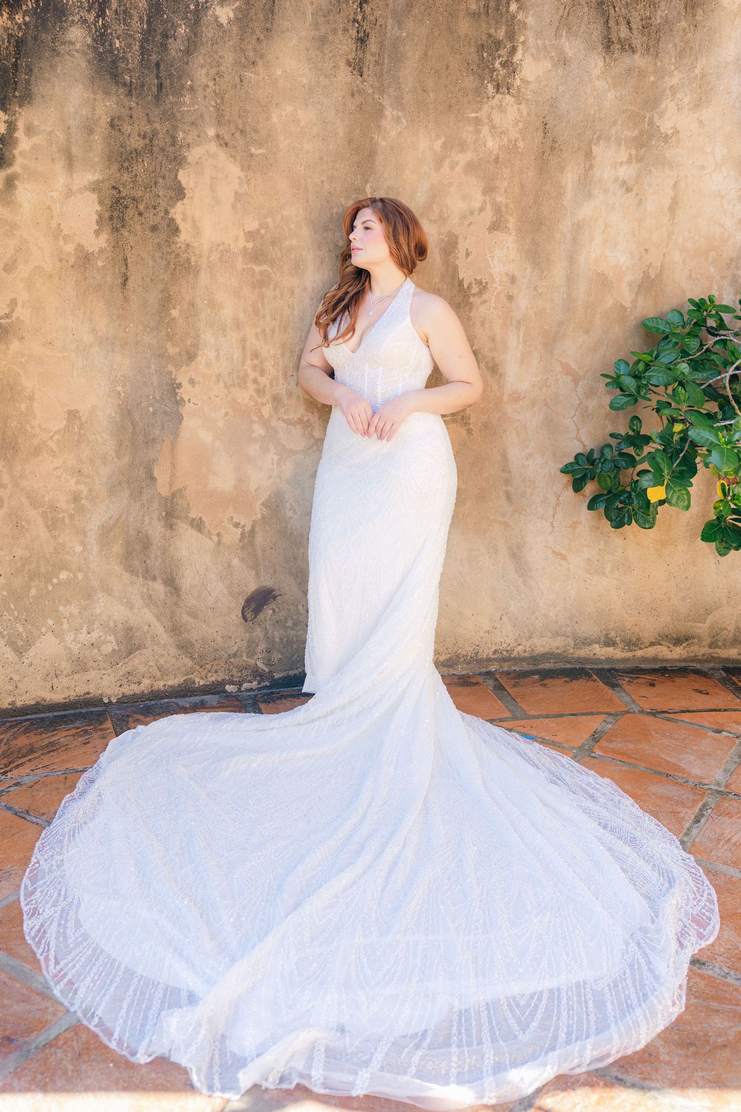 Sequence of a white dress twirling against a textured stone wall backdrop.