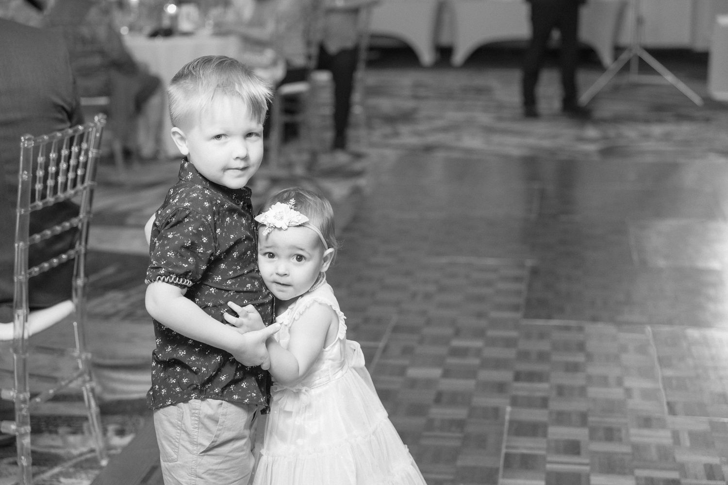 Wedding guests dancing together in a ballroom during a celebration.