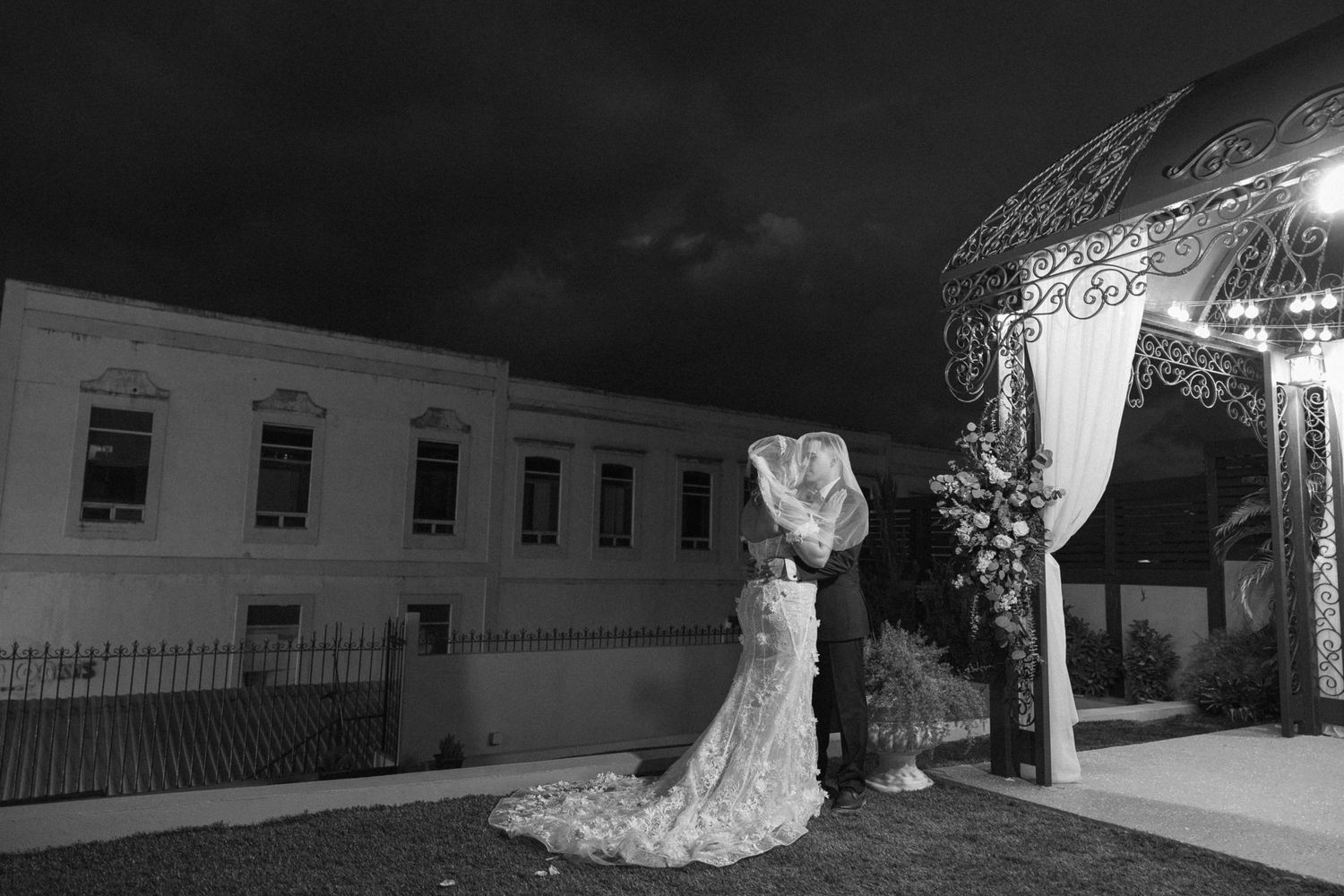 A black and white architectural photograph of historic buildings with dramatic shadows.