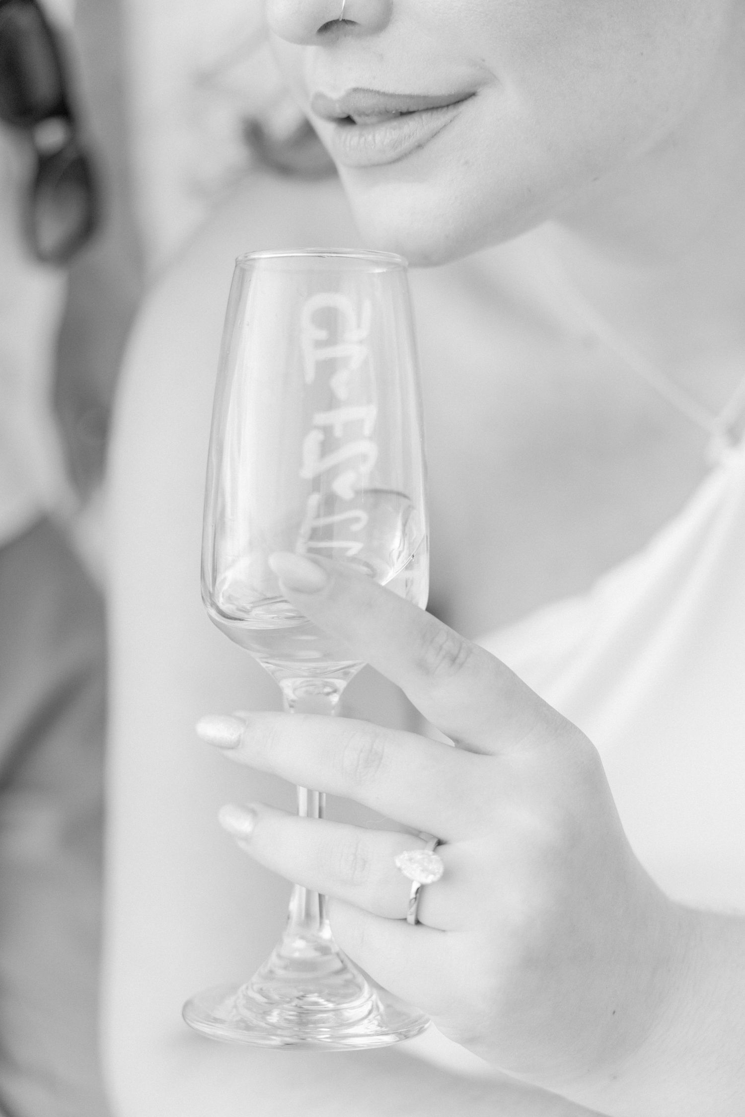 Black and white close-ups of wine glasses being held with elegant gestures.