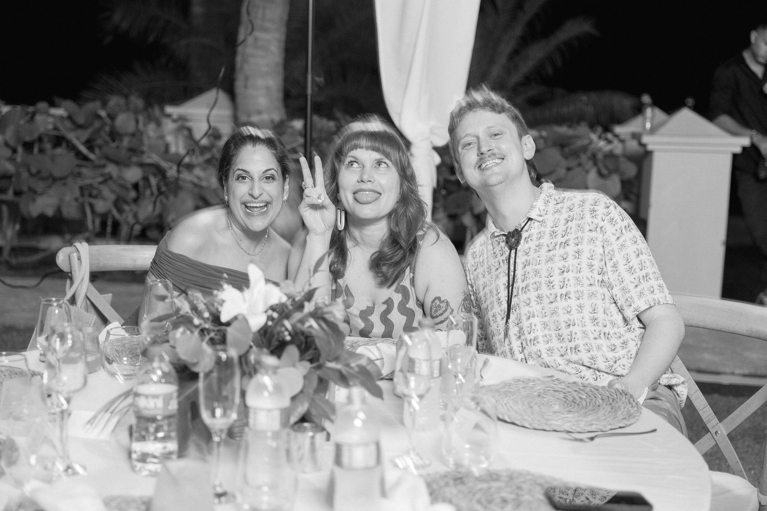 Wedding reception guests seated at tables enjoying dinner and conversation.