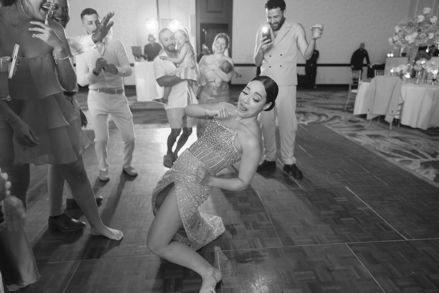 Wedding guests dancing and having fun during a lively reception celebration.