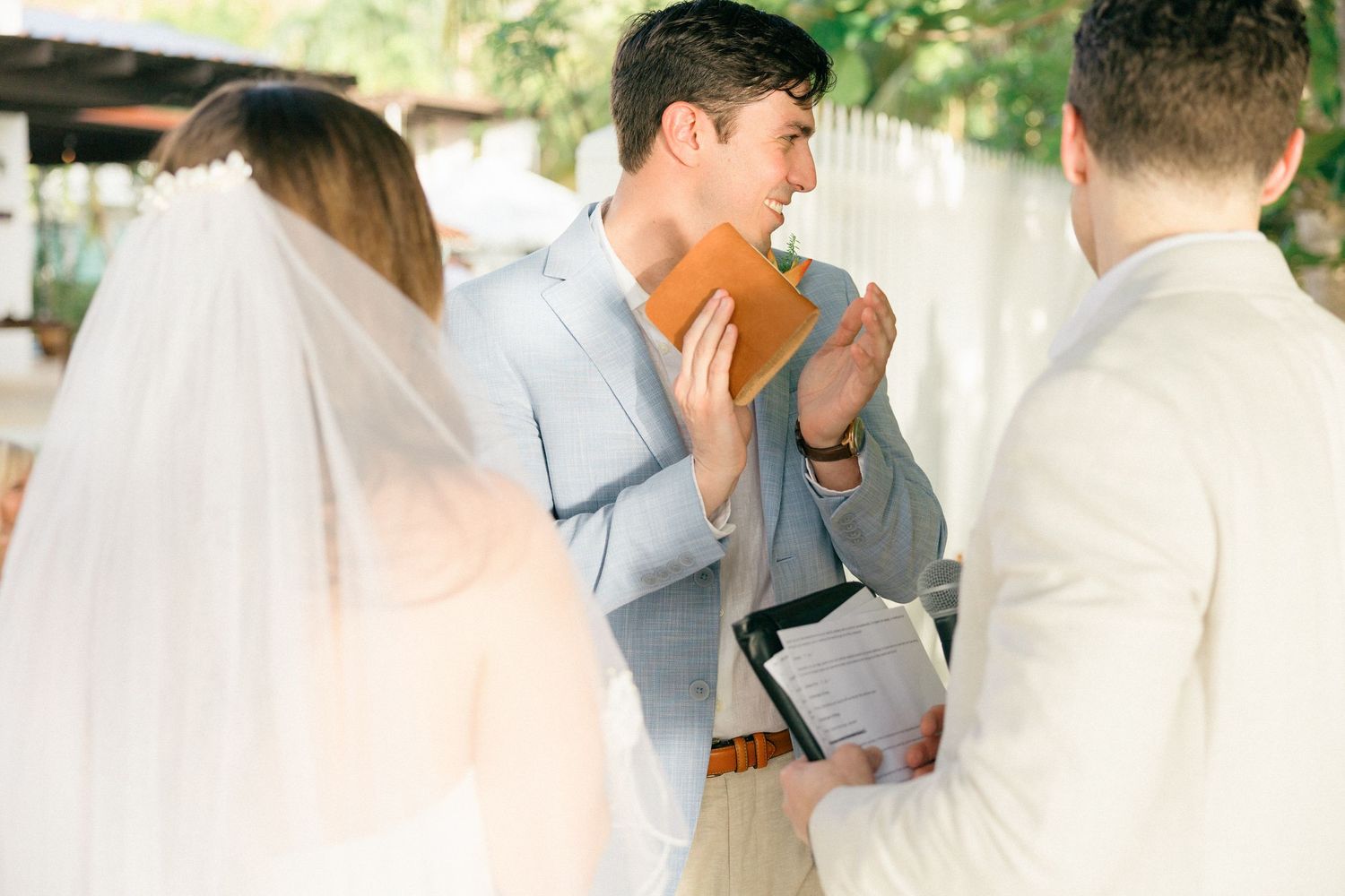 Candid moments captured during an outdoor wedding ceremony with natural lighting.