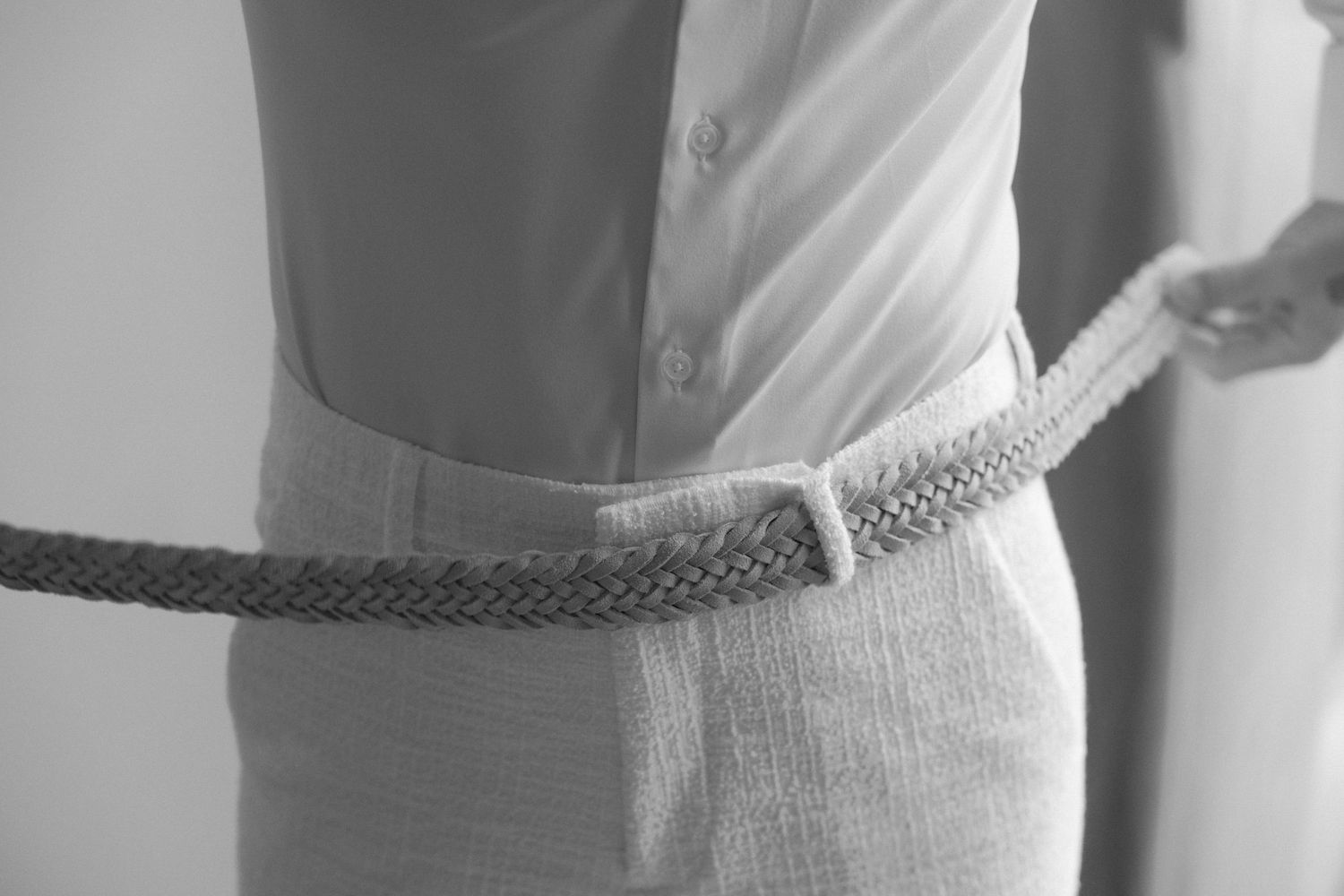 Black and white detail of measuring or fitting with braided cord.